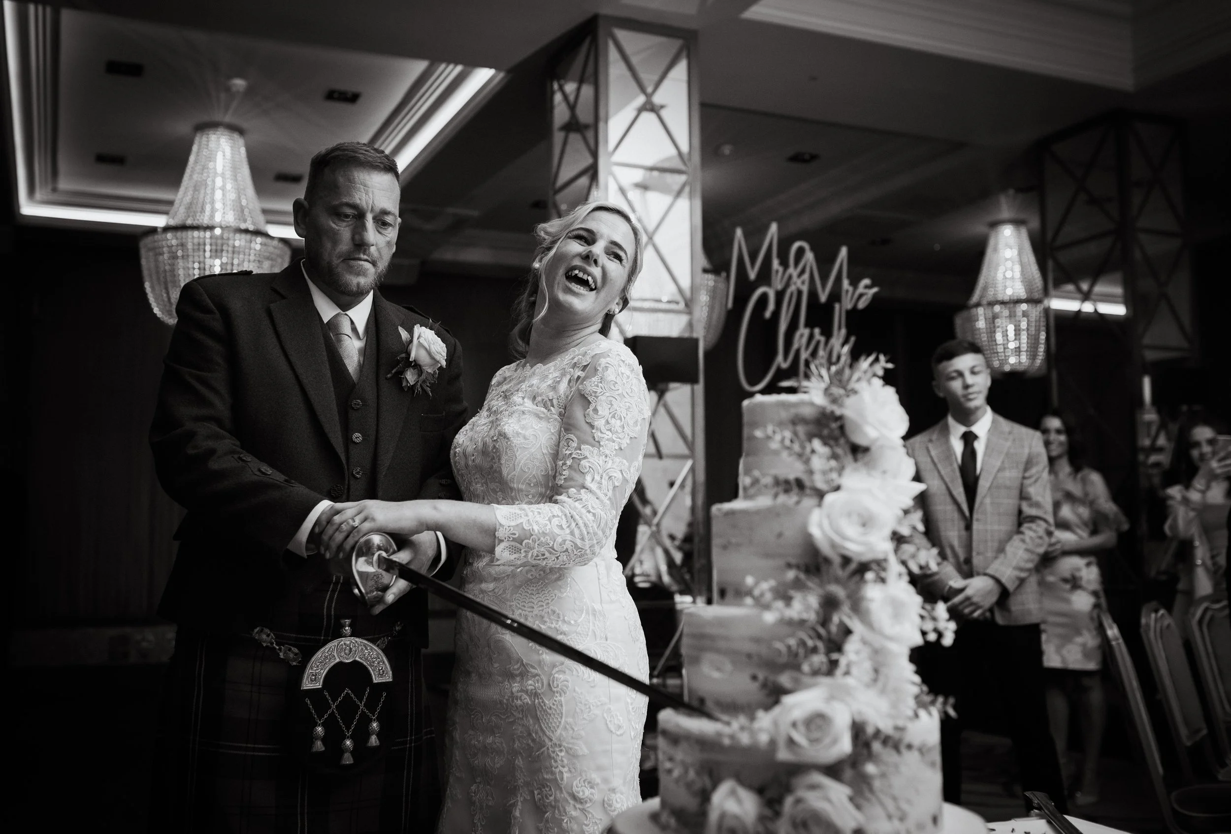 Bride and groom cutting the cake, smiling