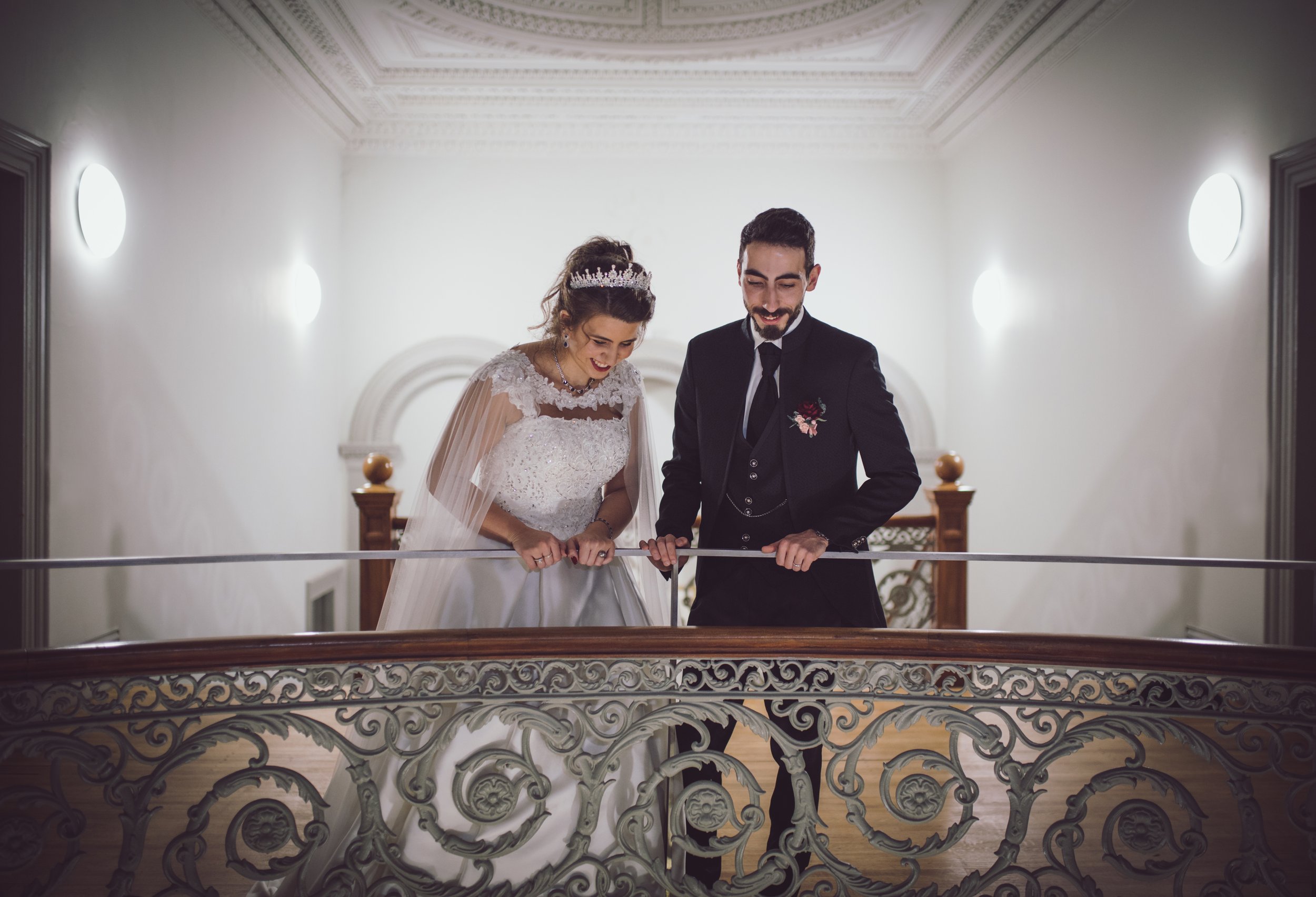 Bride and groom together on a wedding venue balcony