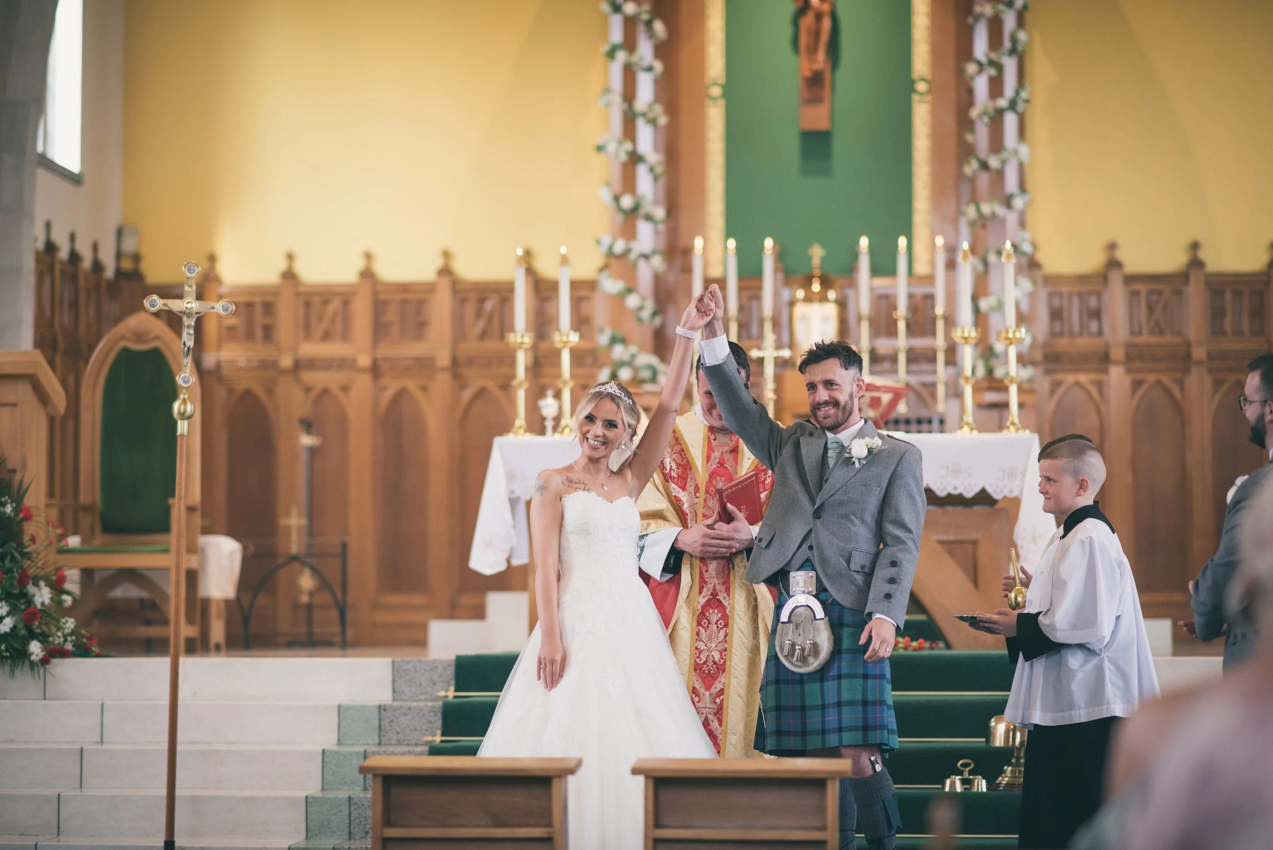 Newlywed couple celebrating at the altar after their wedding ceremony