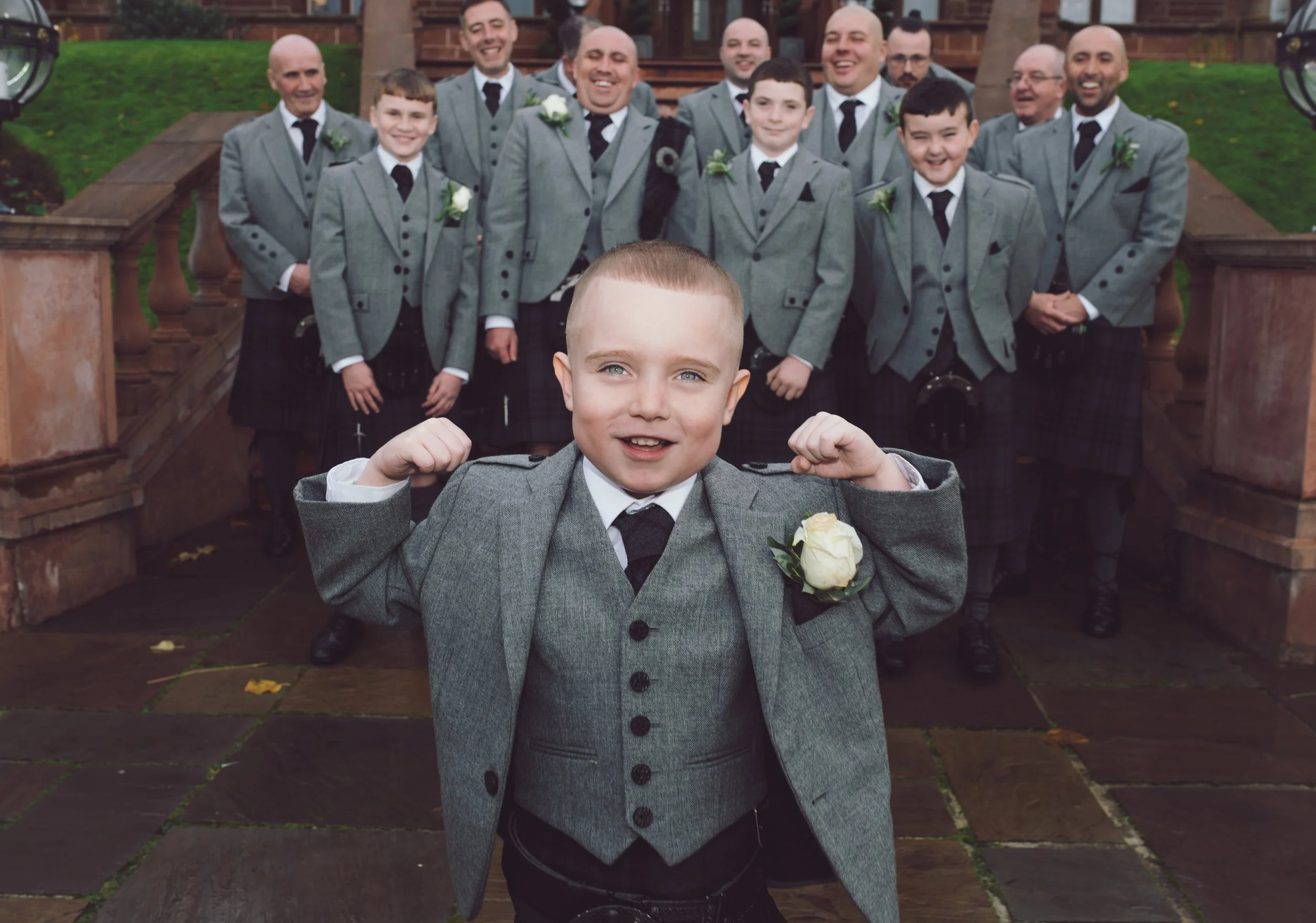 Young page boy celebrating with the wedding part during a joyful wedding day in Scotland