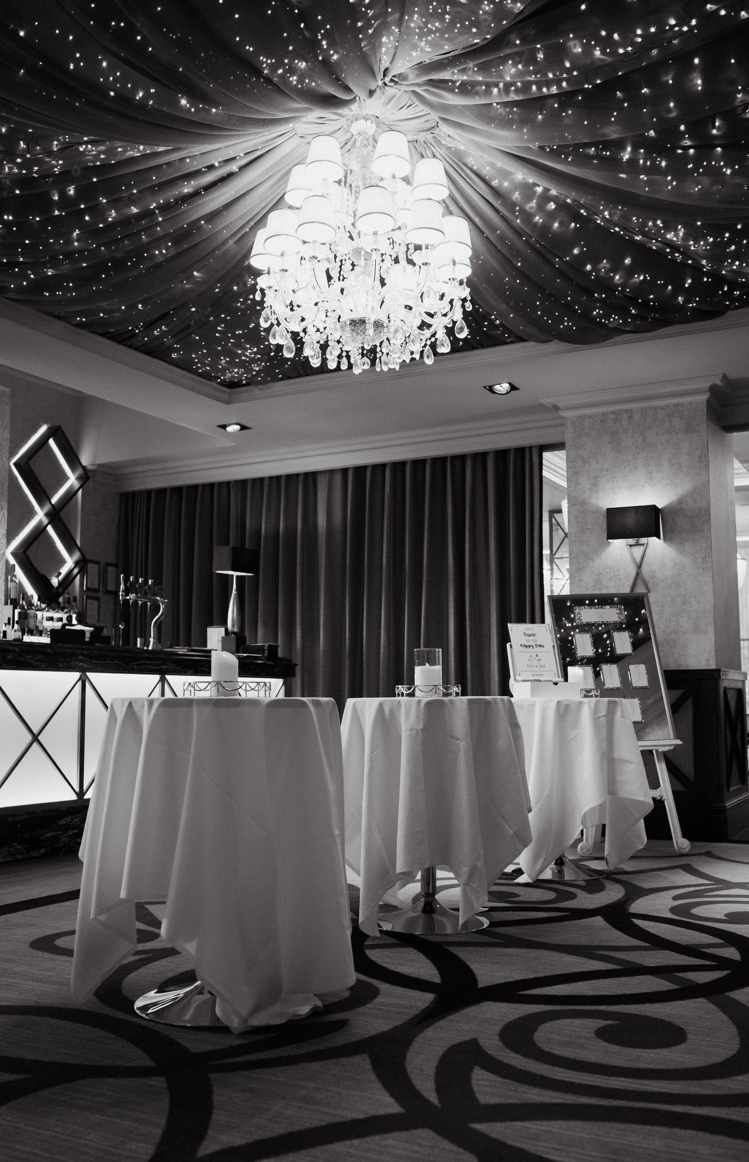 Chandelier and twinkling lights above the wedding reception