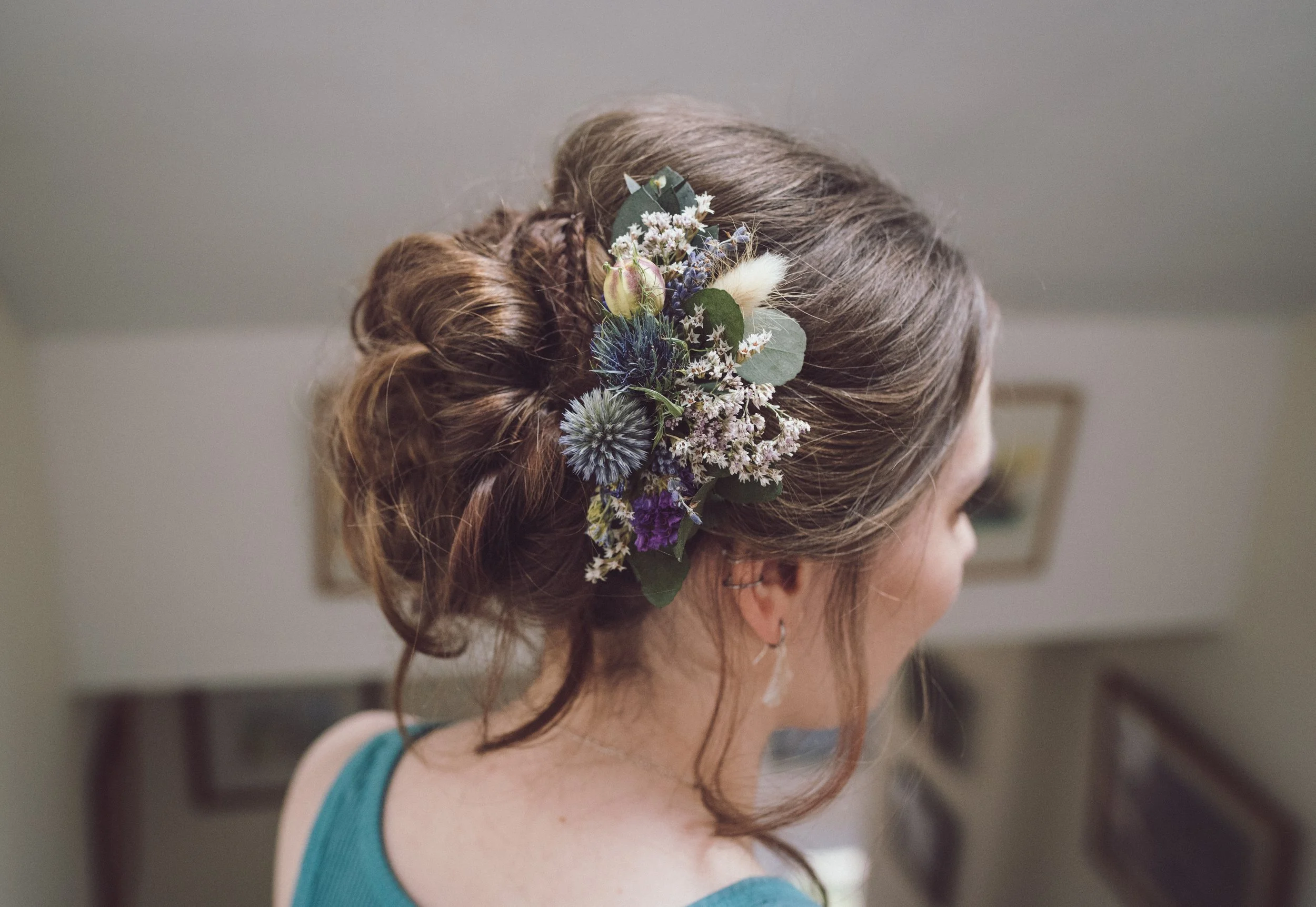 Bride's hair decorated with delicate flowers on her wedding day