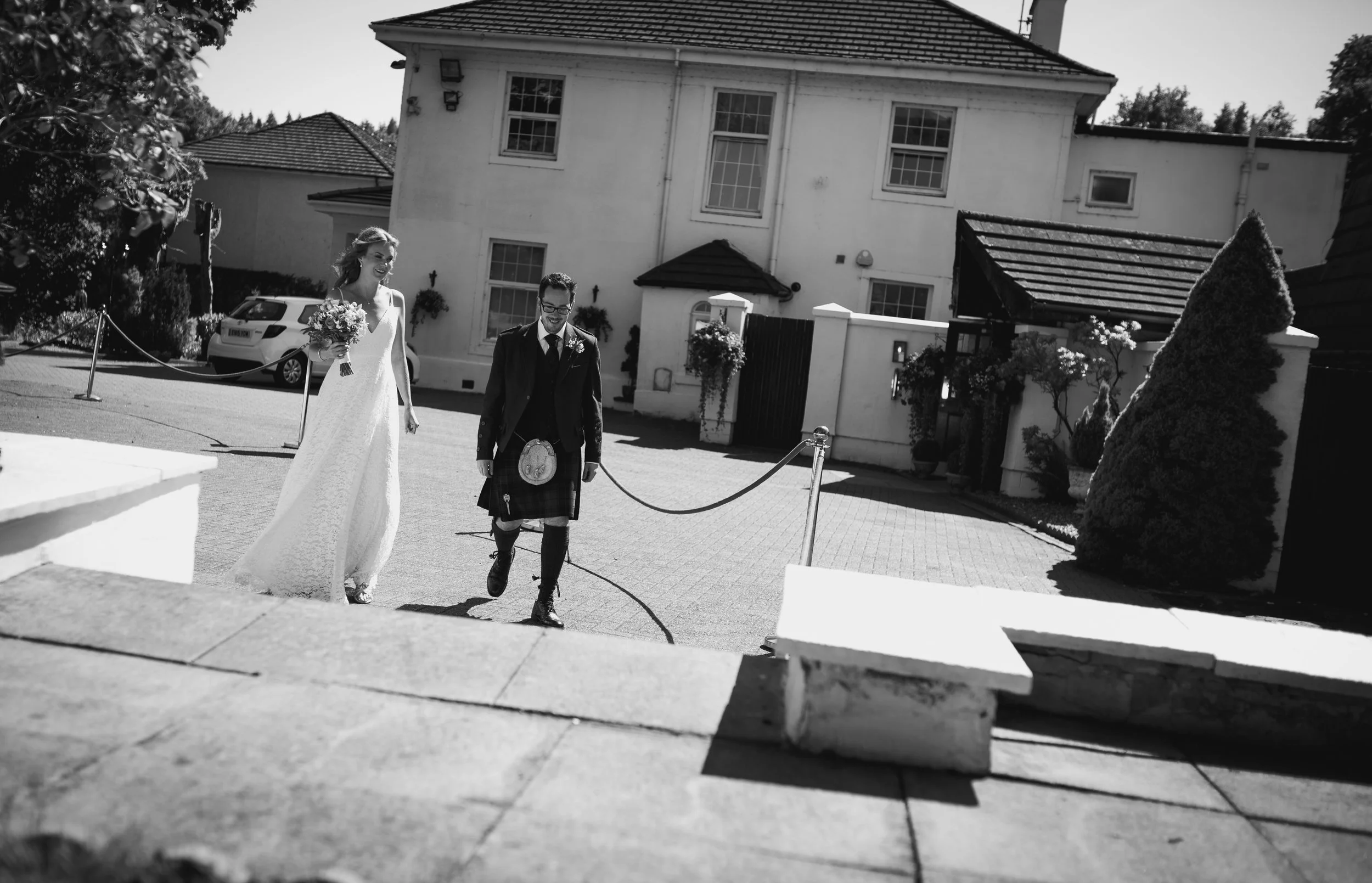 Bride and groom walking together through the grounds of their wedding venue