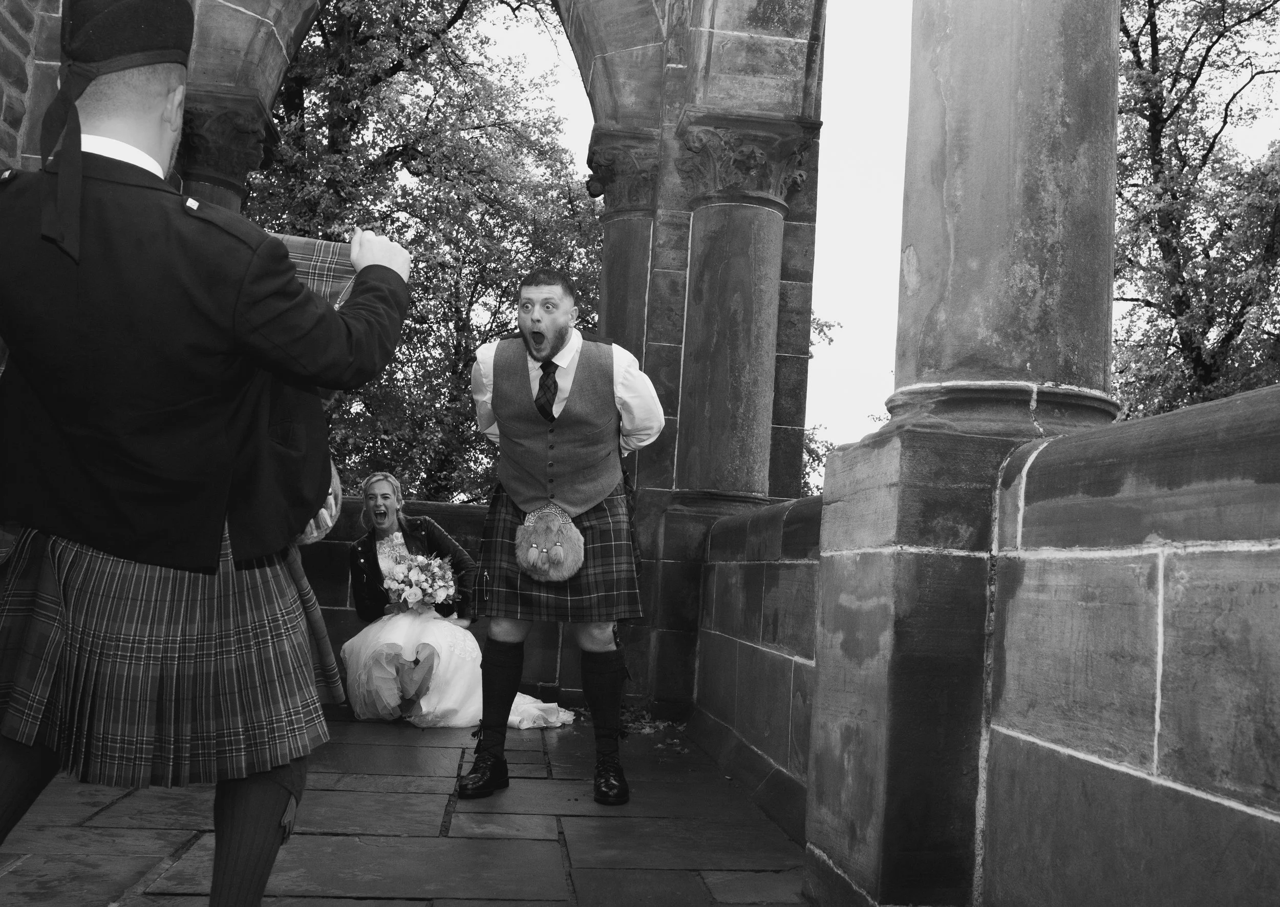 Wedding guests sharing a light hearted moment outside wedding venue
