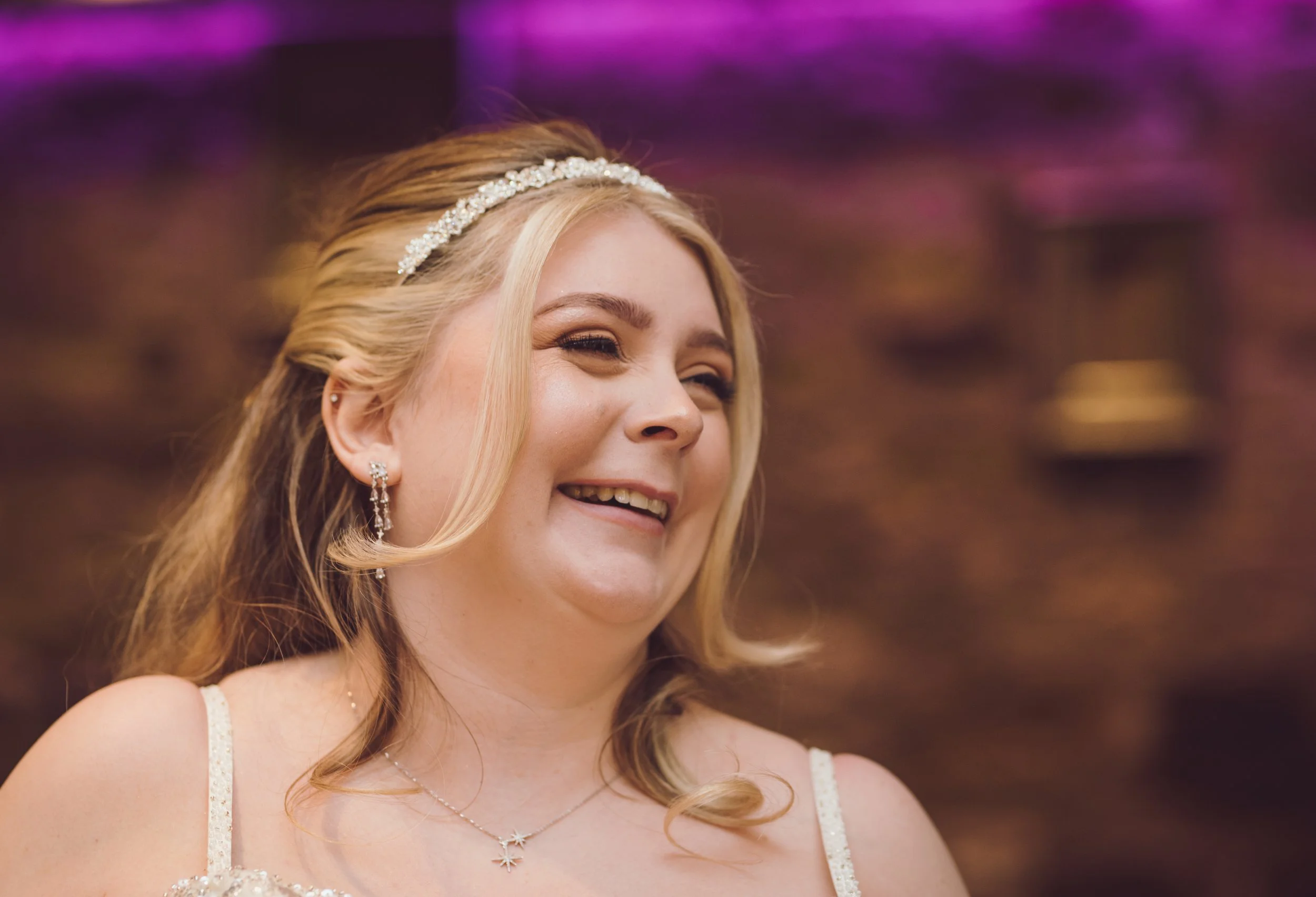 Happy bride laughing during her wedding reception at Citation Glasgow
