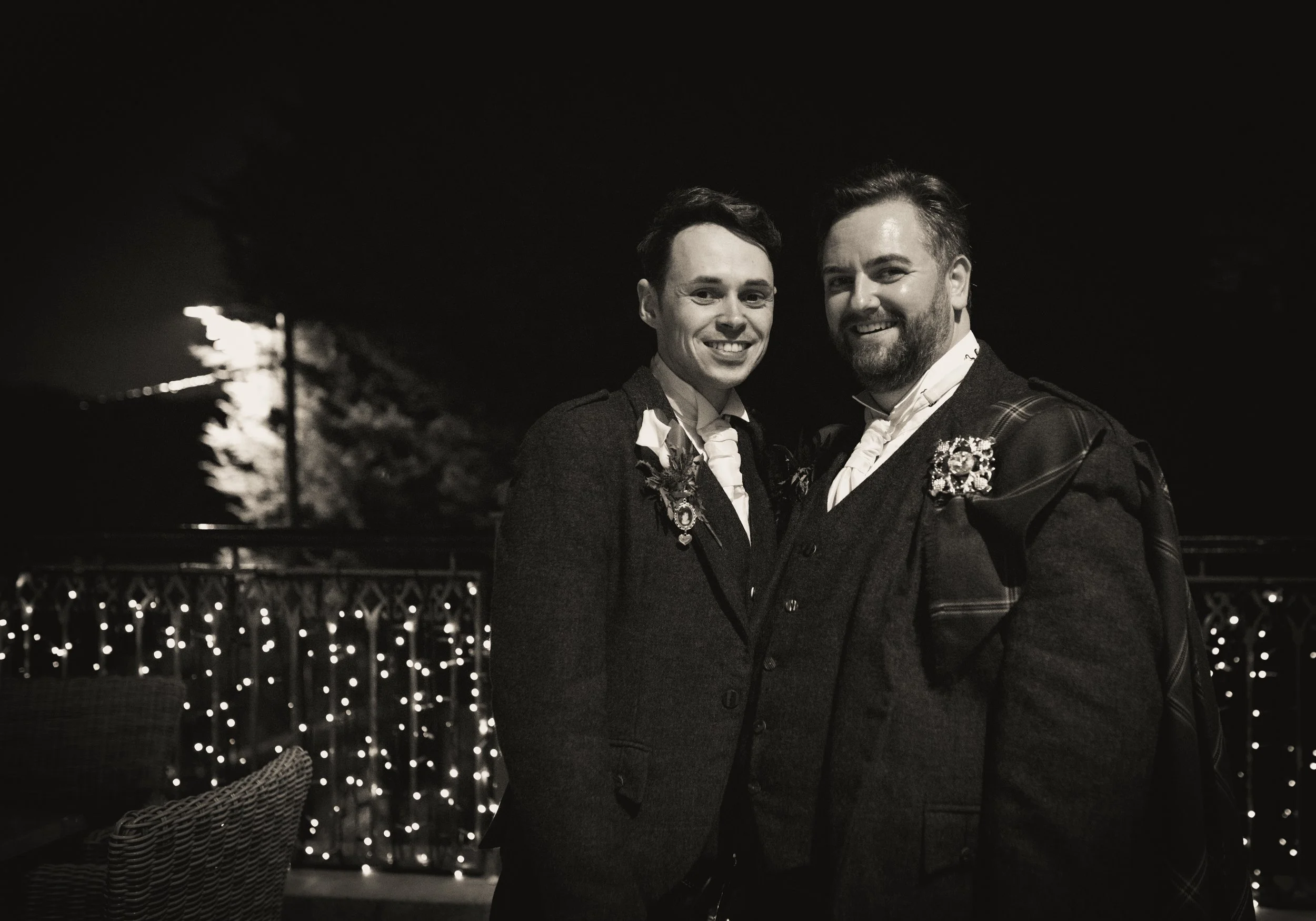 Grooms smiling at their wedding reception