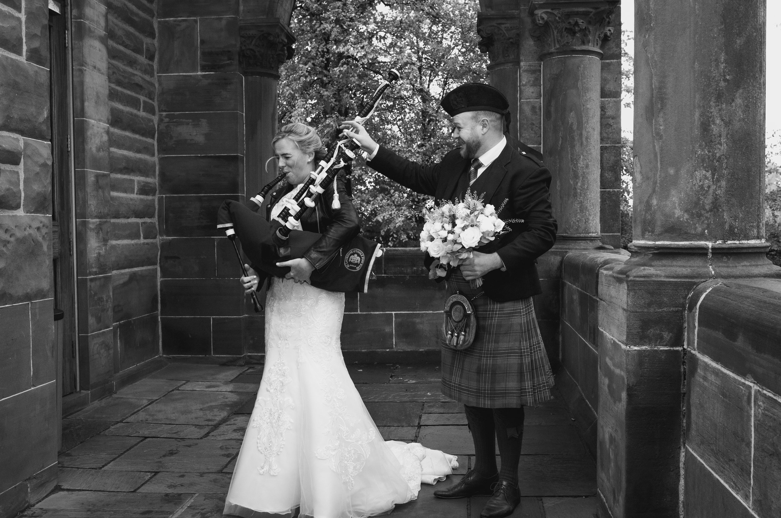Bride and piper having fun