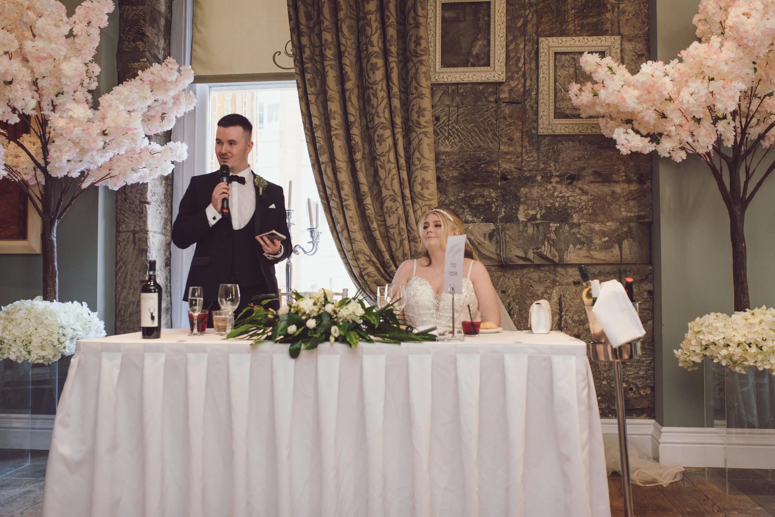 Groom giving a speech to guests at the newlyweds' Citation wedding reception