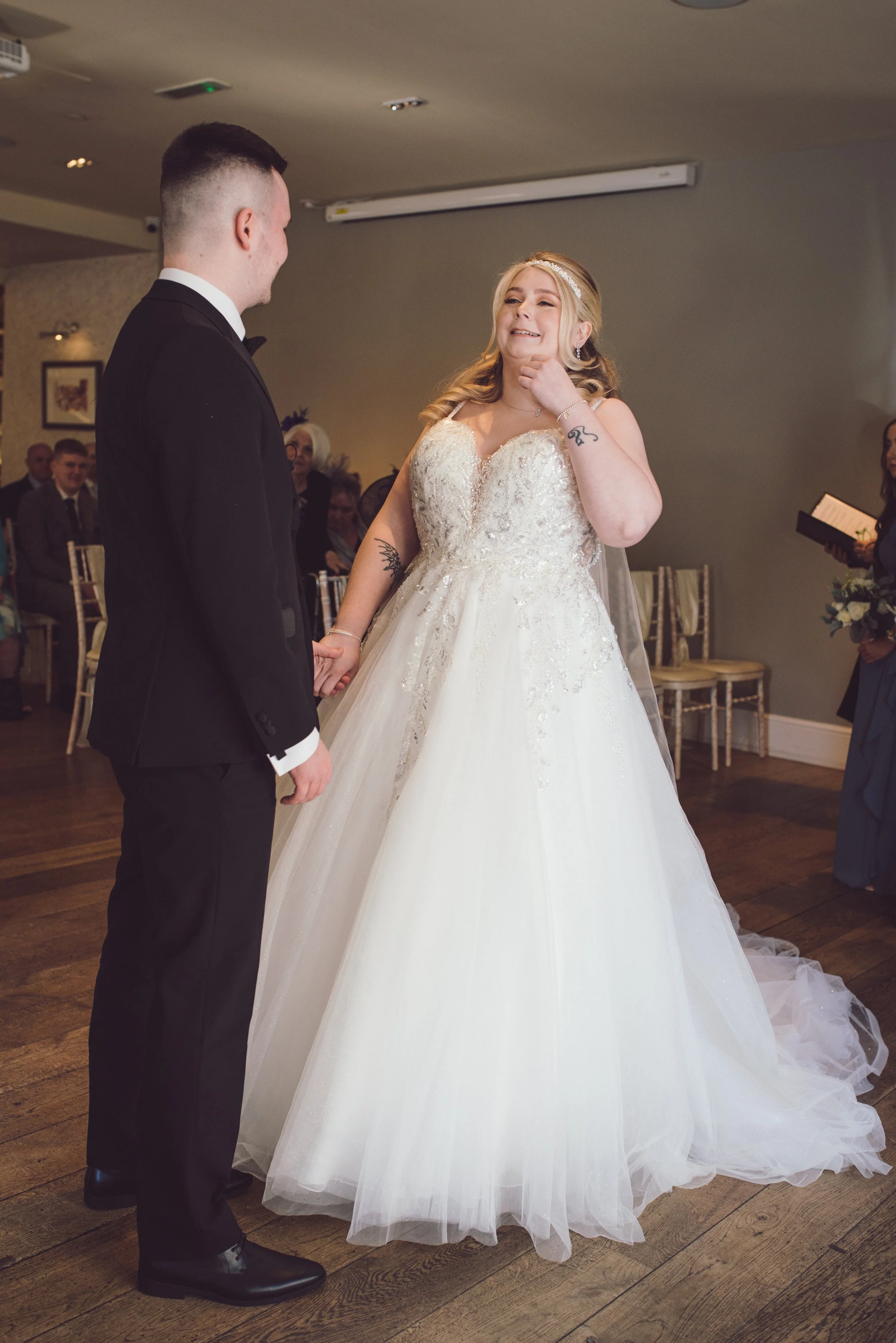 Bride and groom holding hands as they begin their wedding ceremony in Glasgow