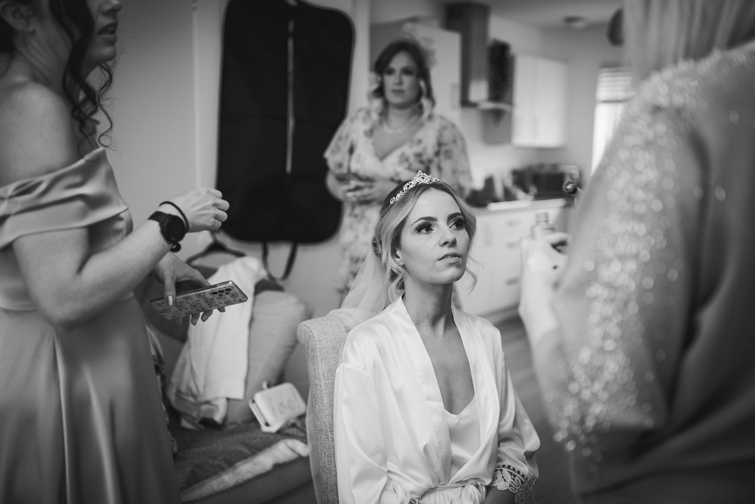 Bride getting ready with her bridesmaids during relaxed wedding preparations