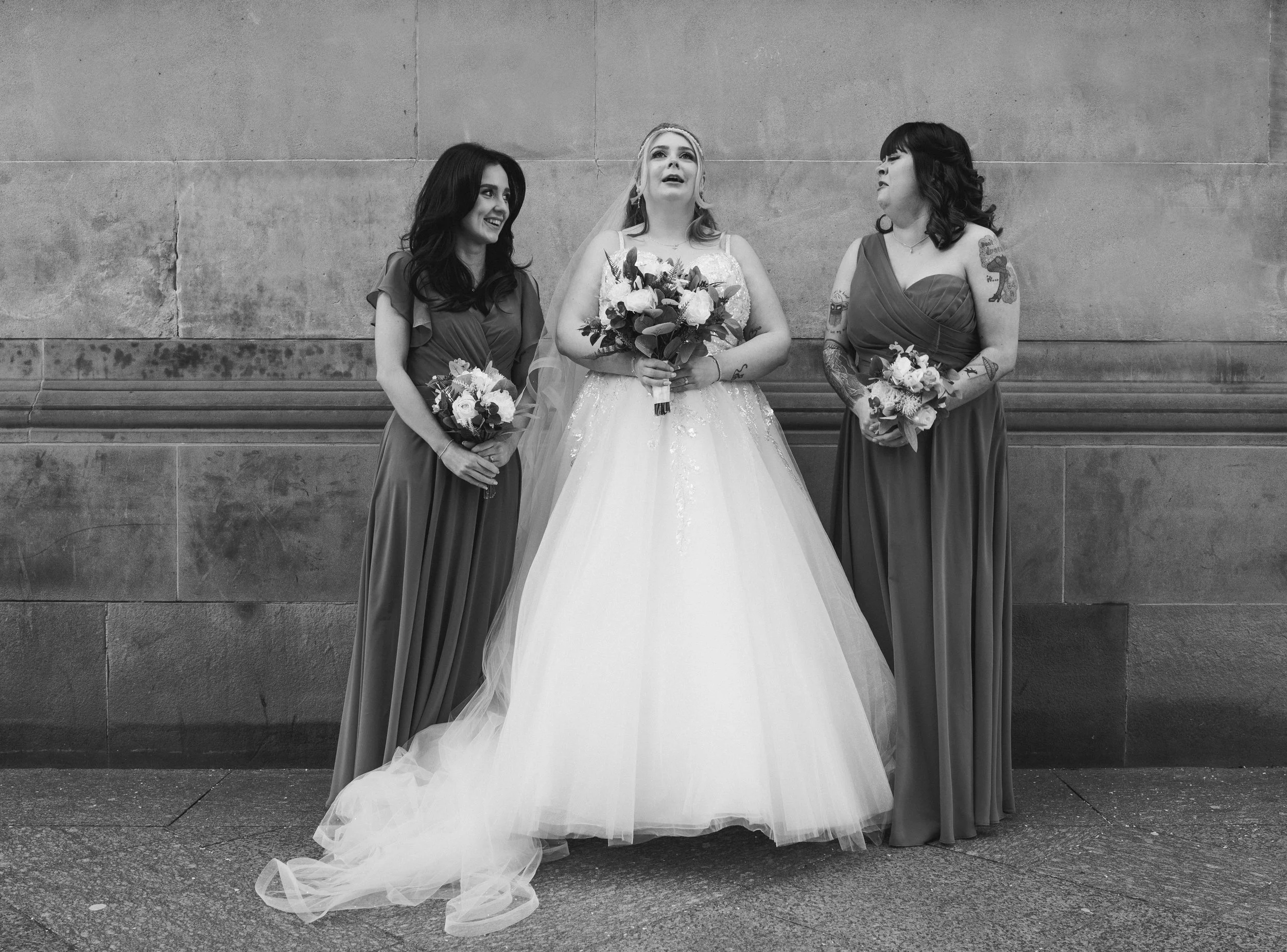Bride posing with her two bridesmaids during a Glasgow city centre wedding