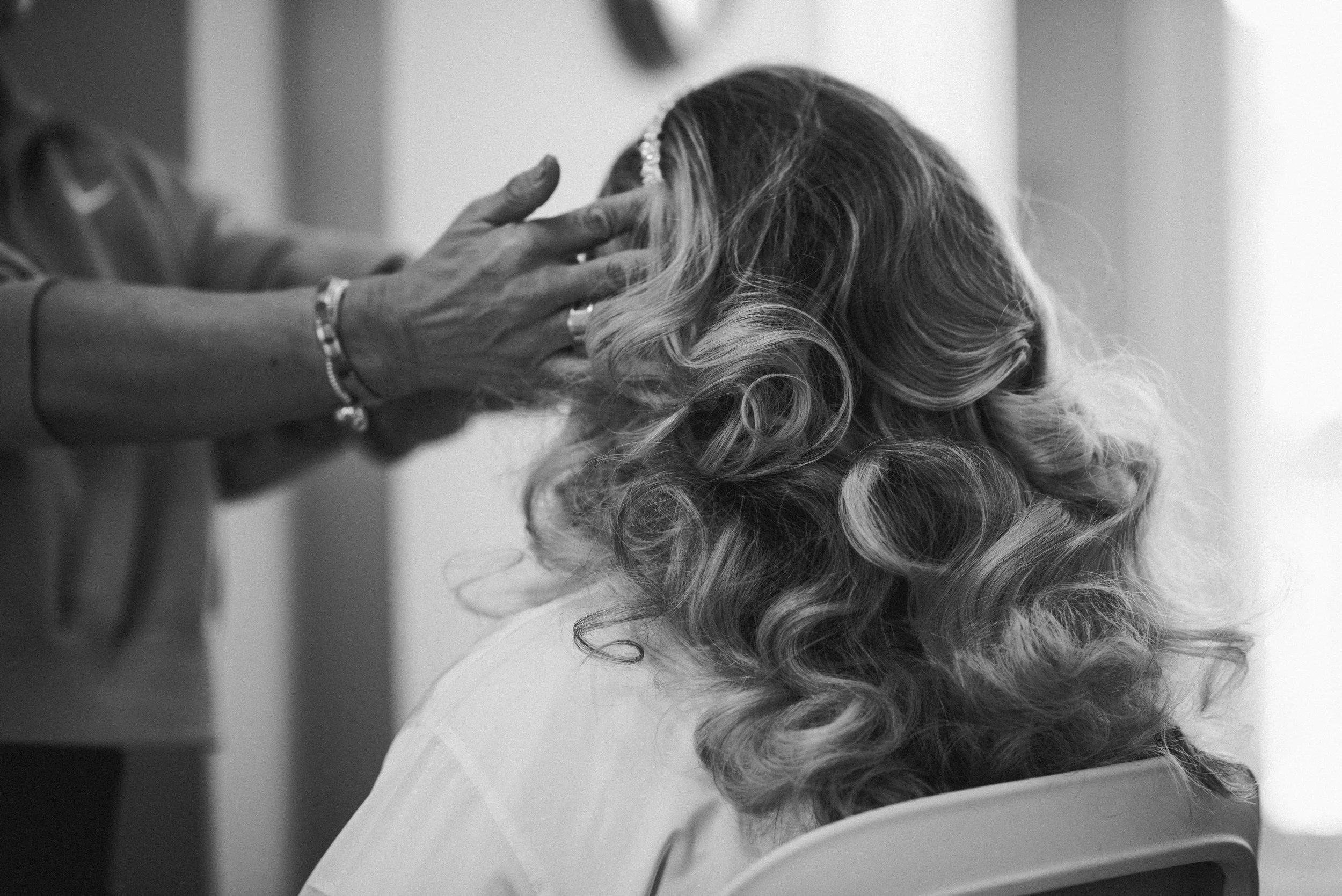Bride having her hair styled during relaxed wedding preparations in Glasgow