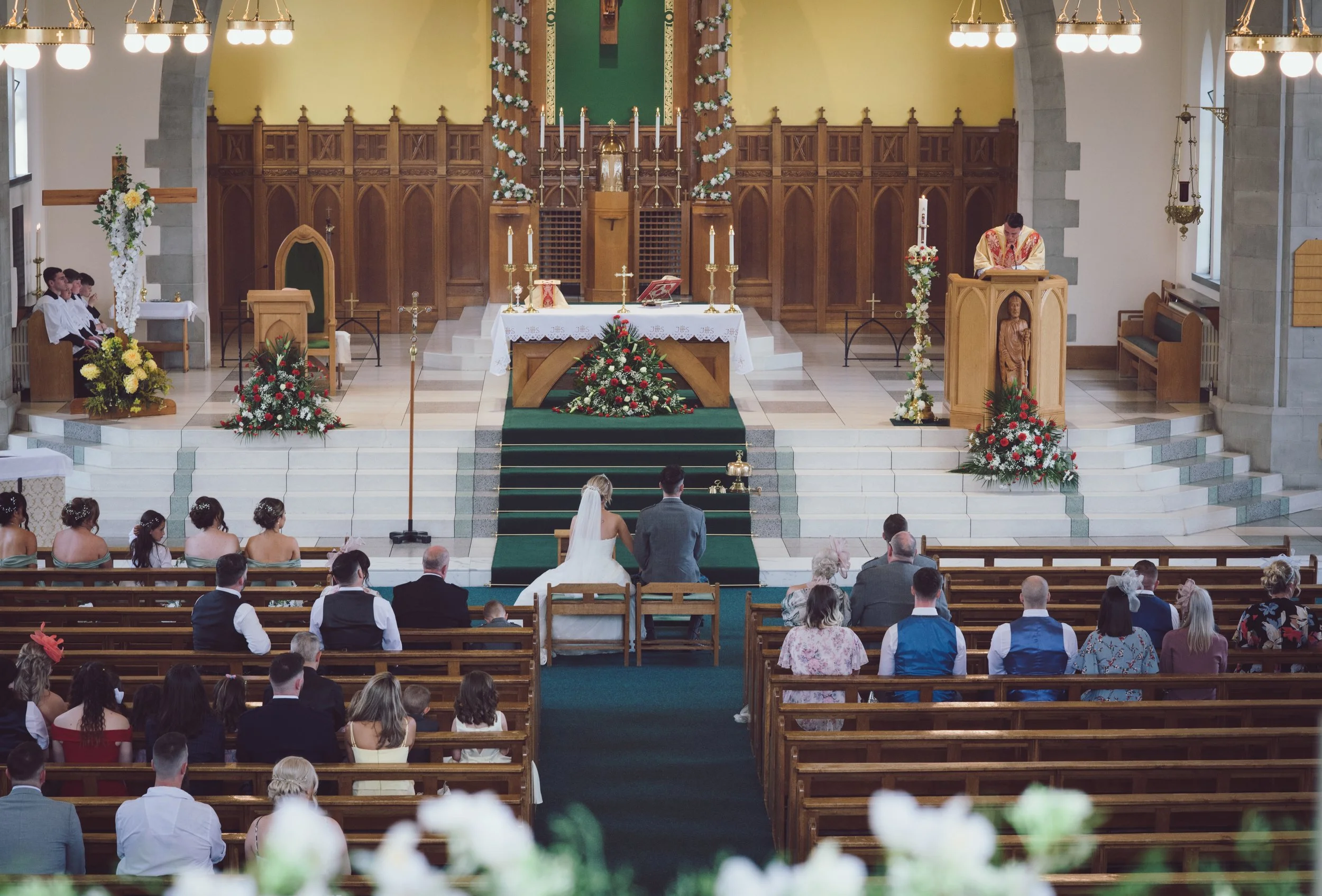 View from church balcony of wedding ceremony and guests
