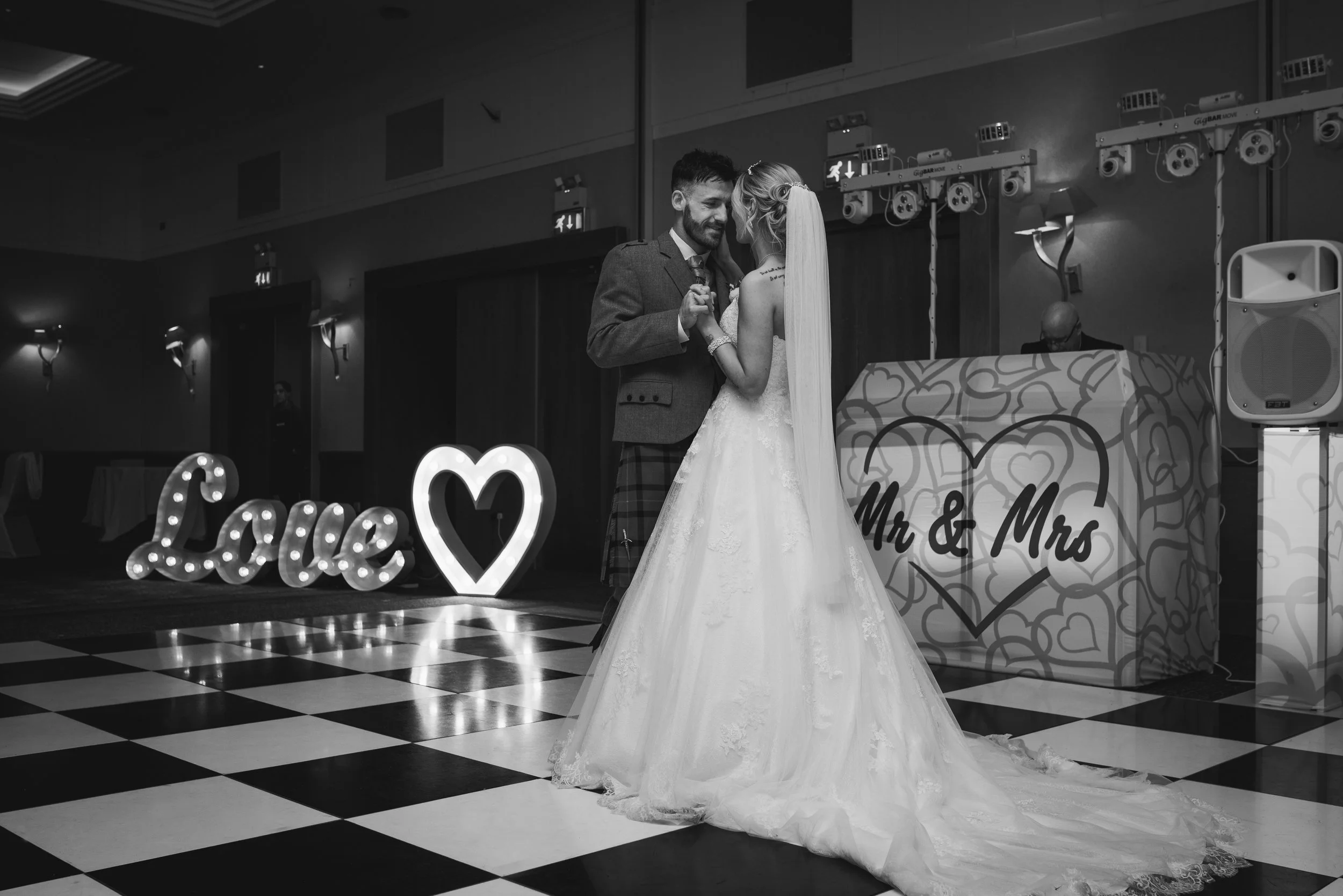 Newlywed couple sharing their first dance at their wedding reception