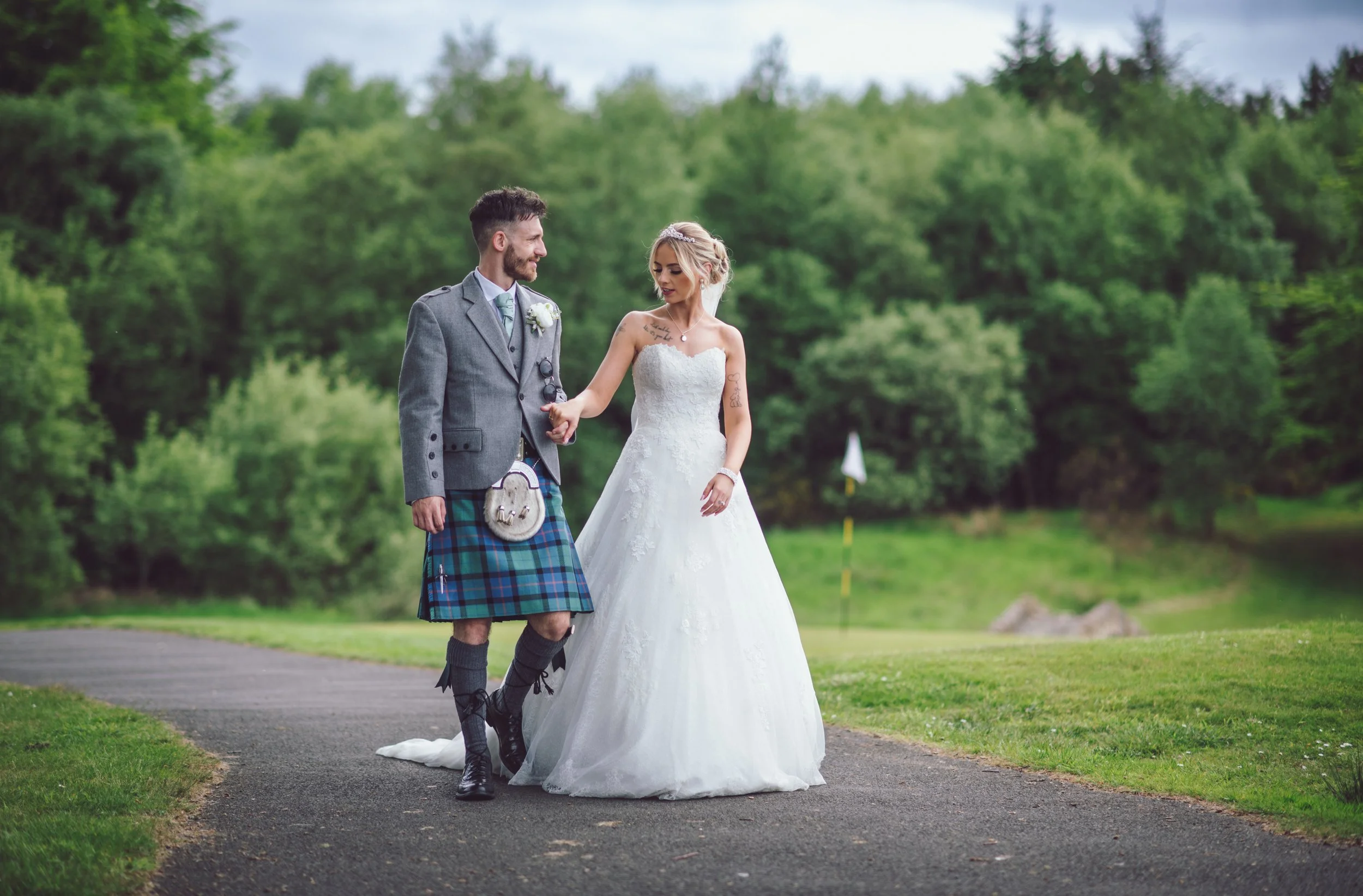 Bride and groom walking together through the grounds of their wedding venue
