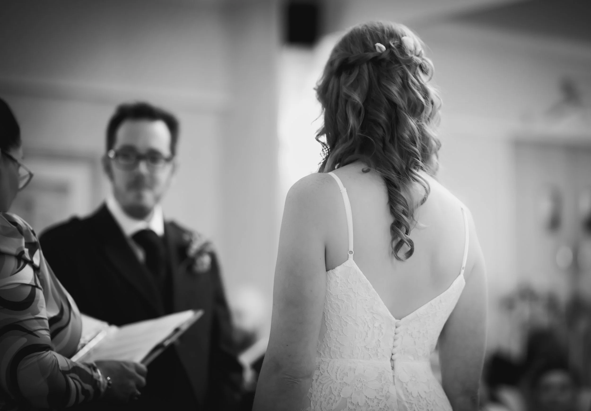 Bride walking towards her wedding ceremony in a lace wedding dress