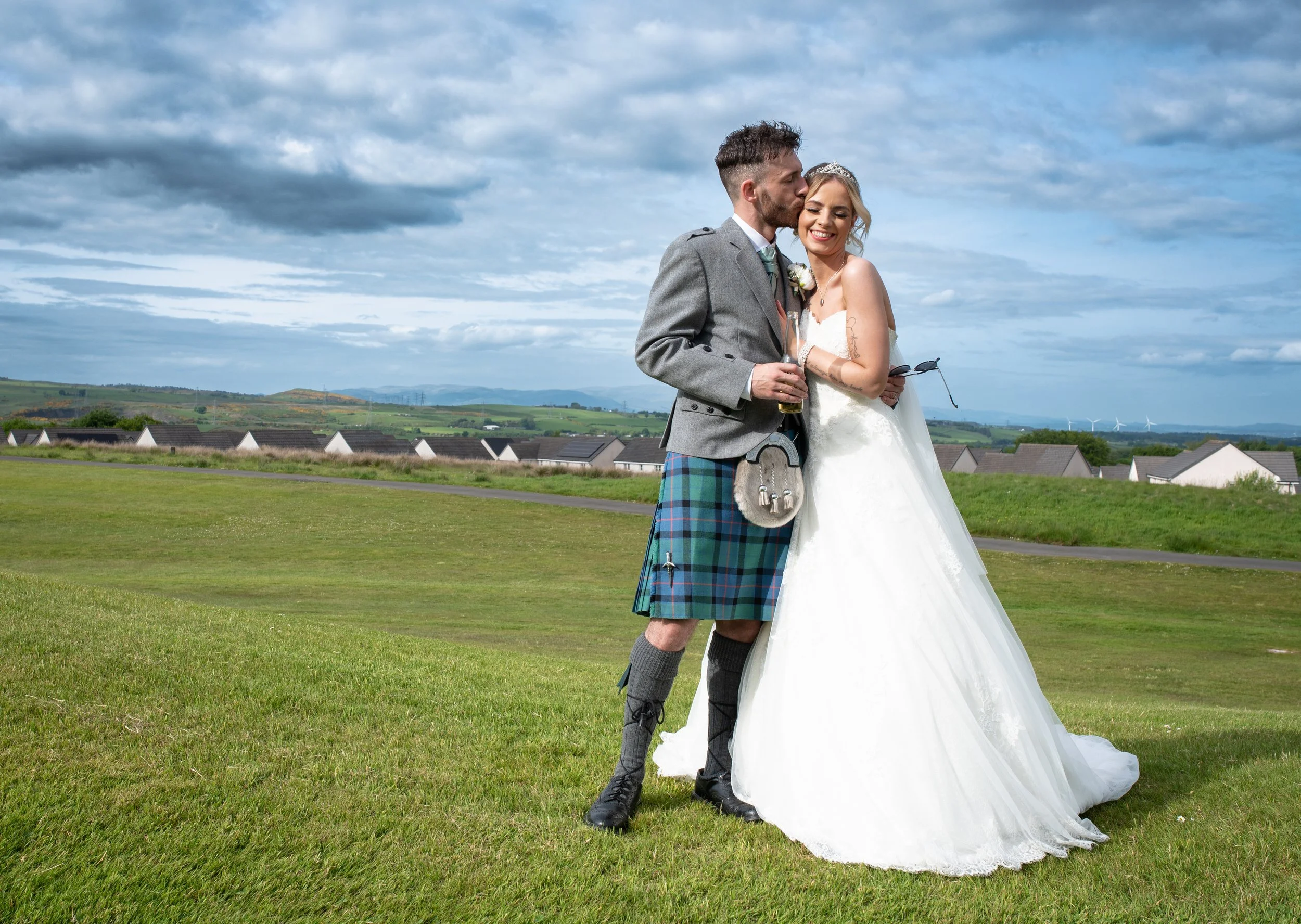 Newlywed couple enjoying a relaxed wedding portrait outdoors