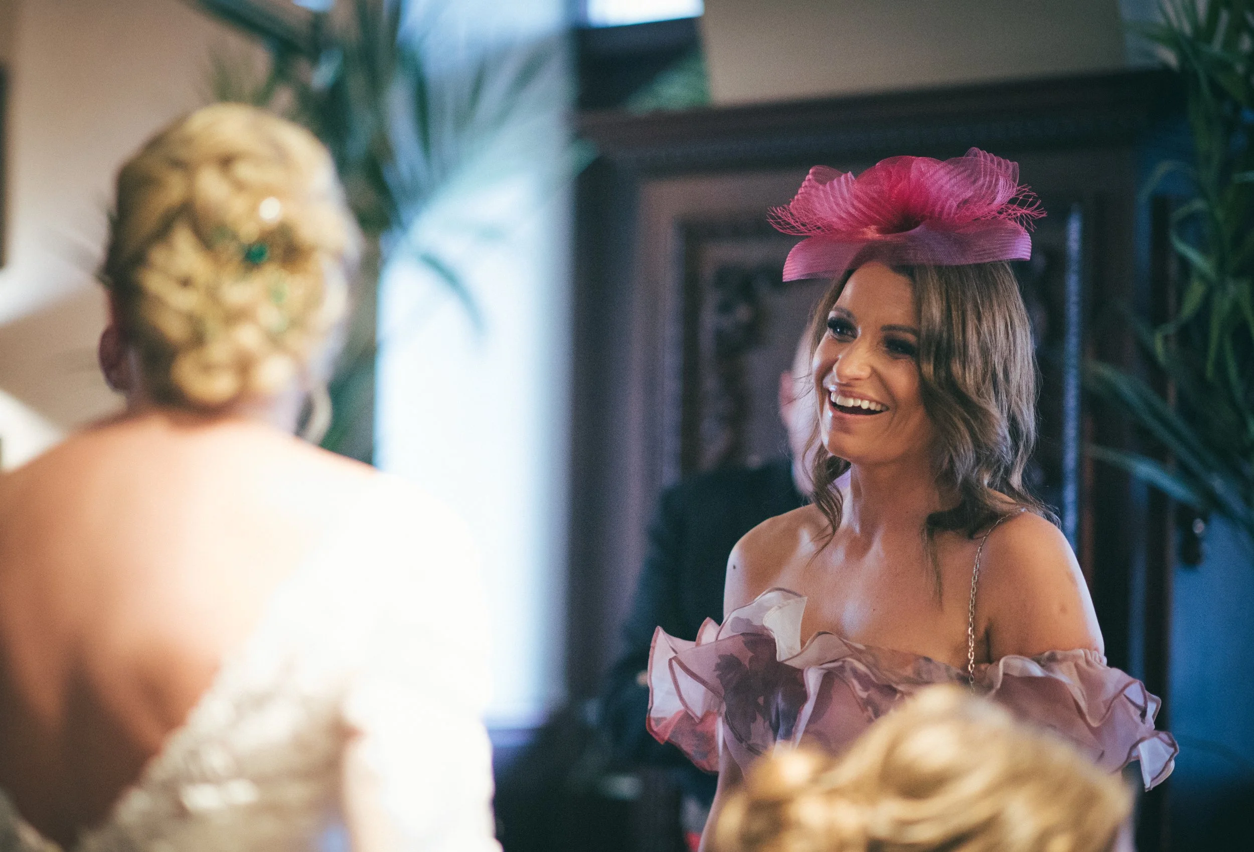 Guest smiling while talking to the bride