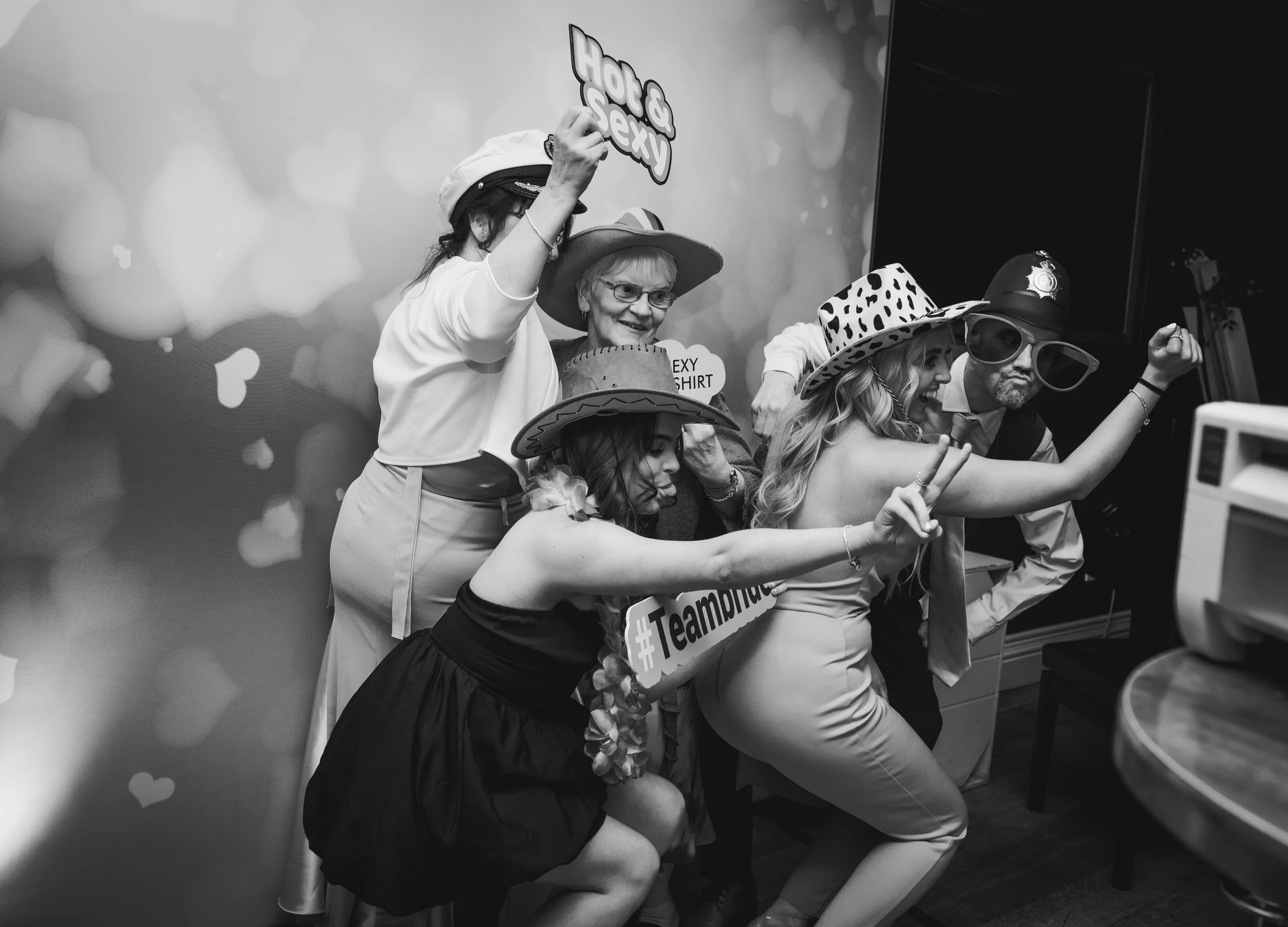 Wedding guests enjoying a fun photo booth during the evening reception