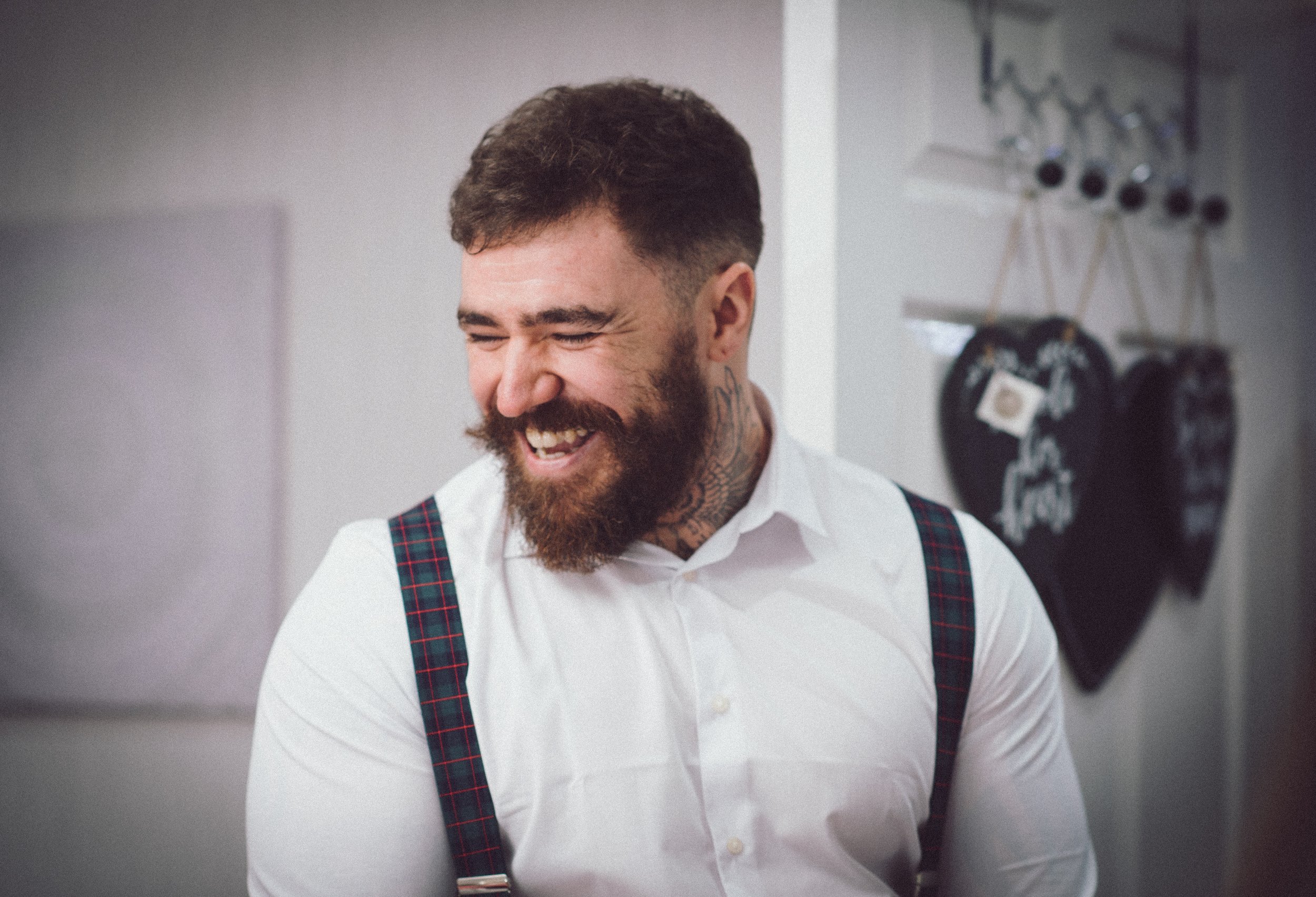 Groomsman laughing during relaxed wedding preparations