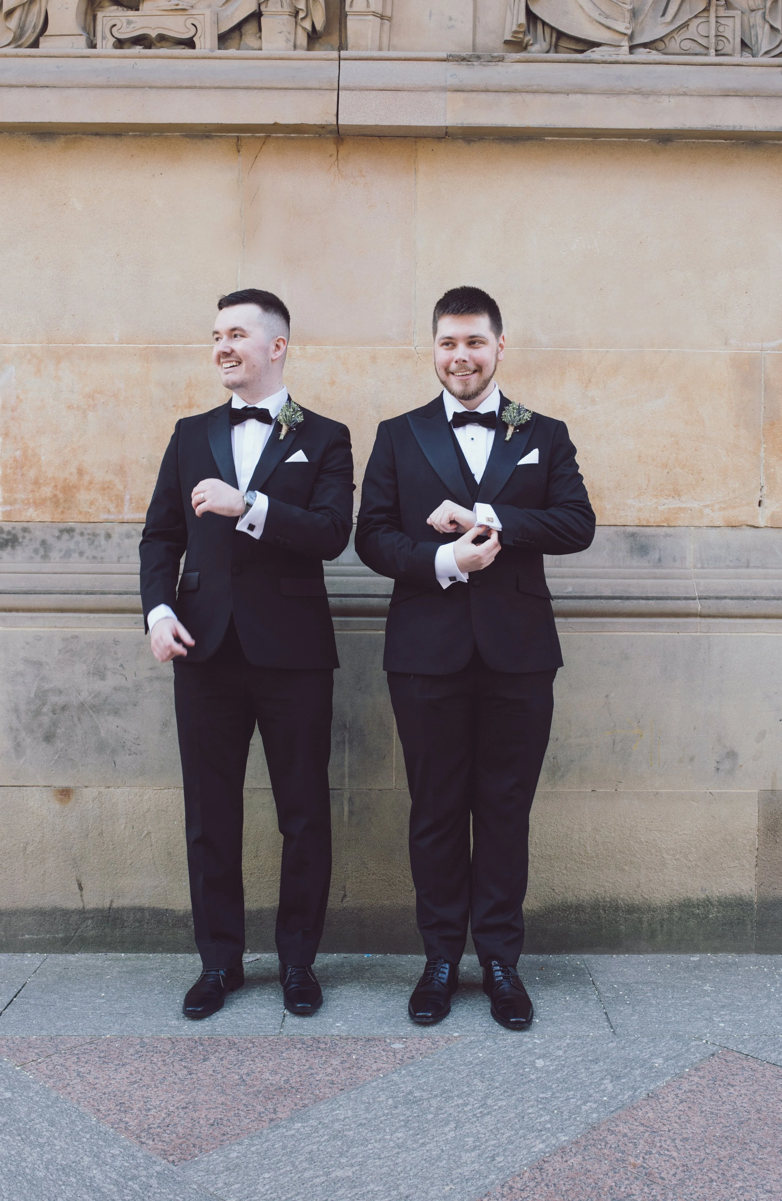 Groom and best man photographed together outside their Glasgow wedding venue