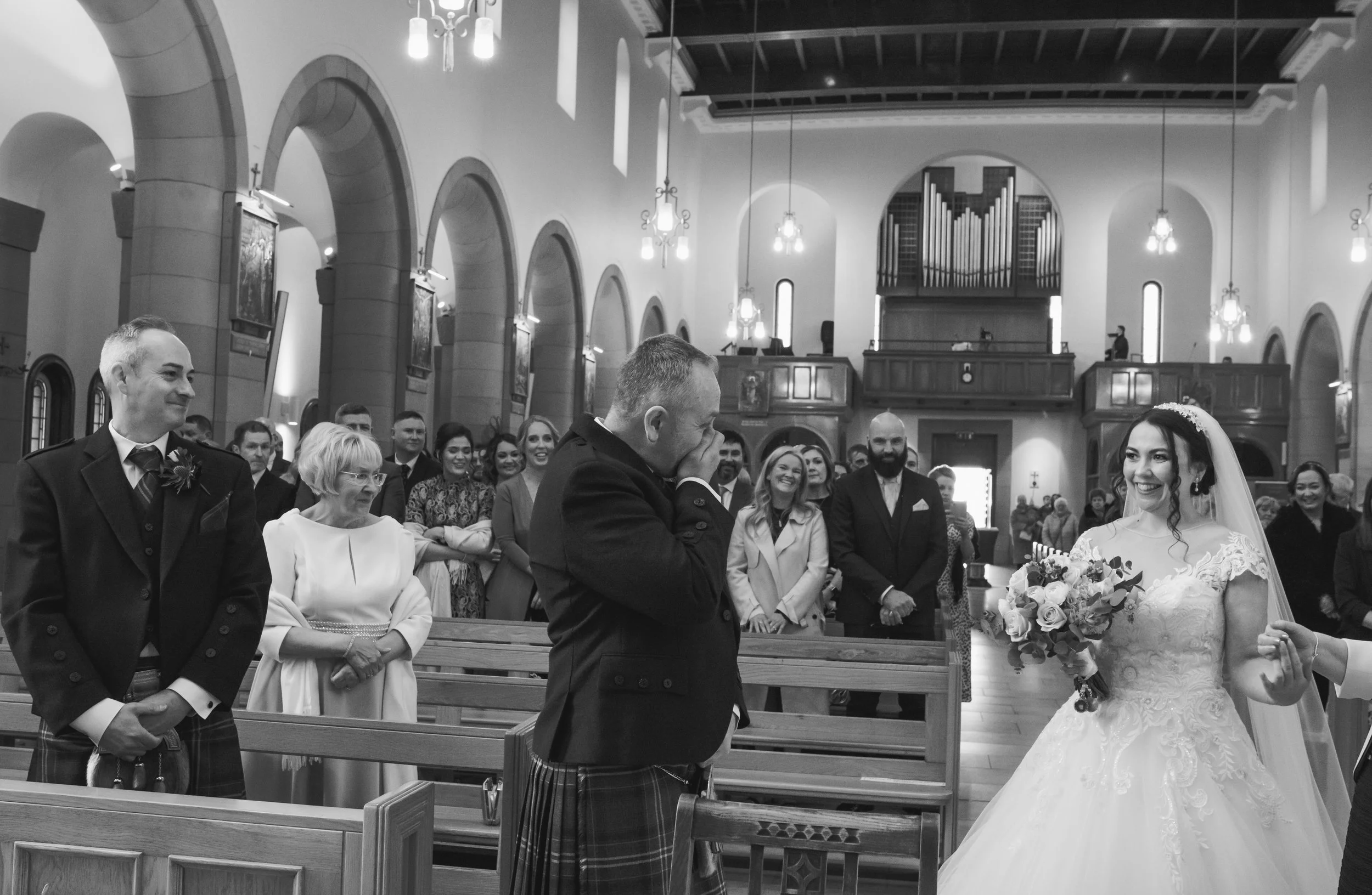 Bride and groom during their wedding ceremony as guests look on