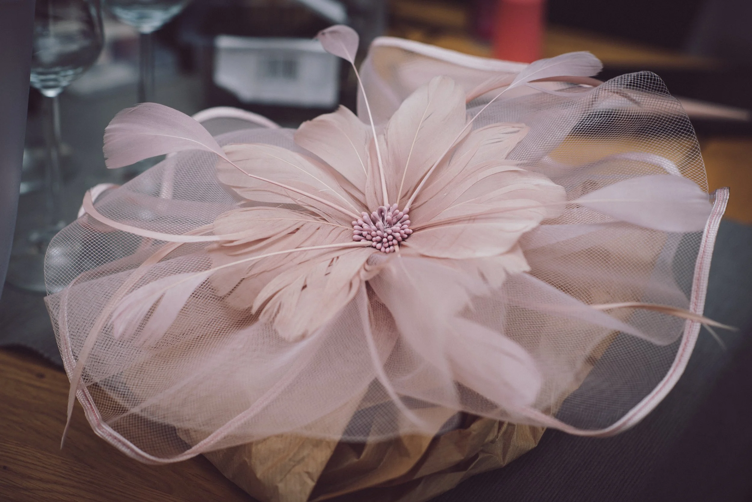 Close-up of a beautiful pink feather wedding fascinator