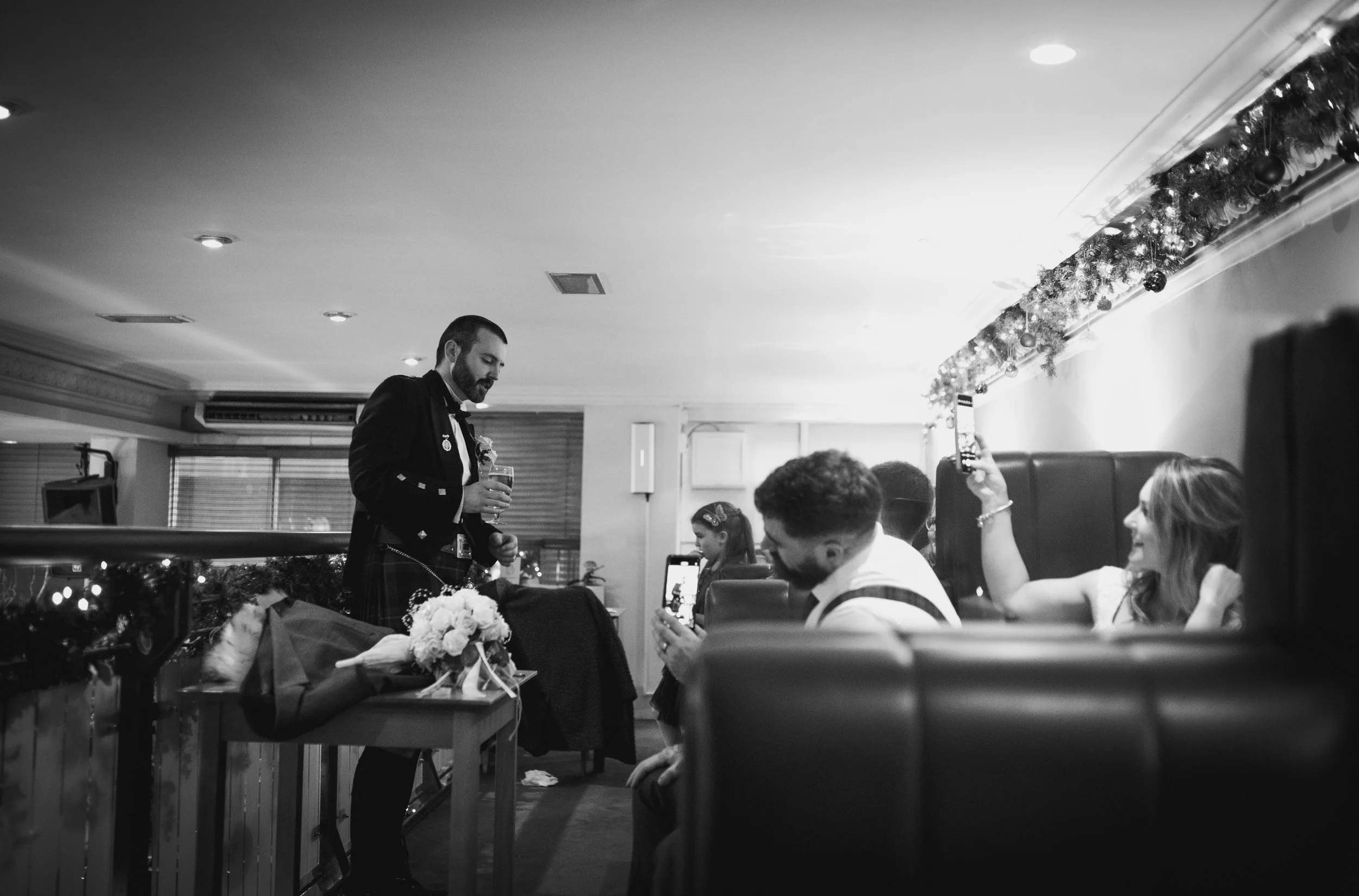 Groom chatting with wedding guests during the reception
