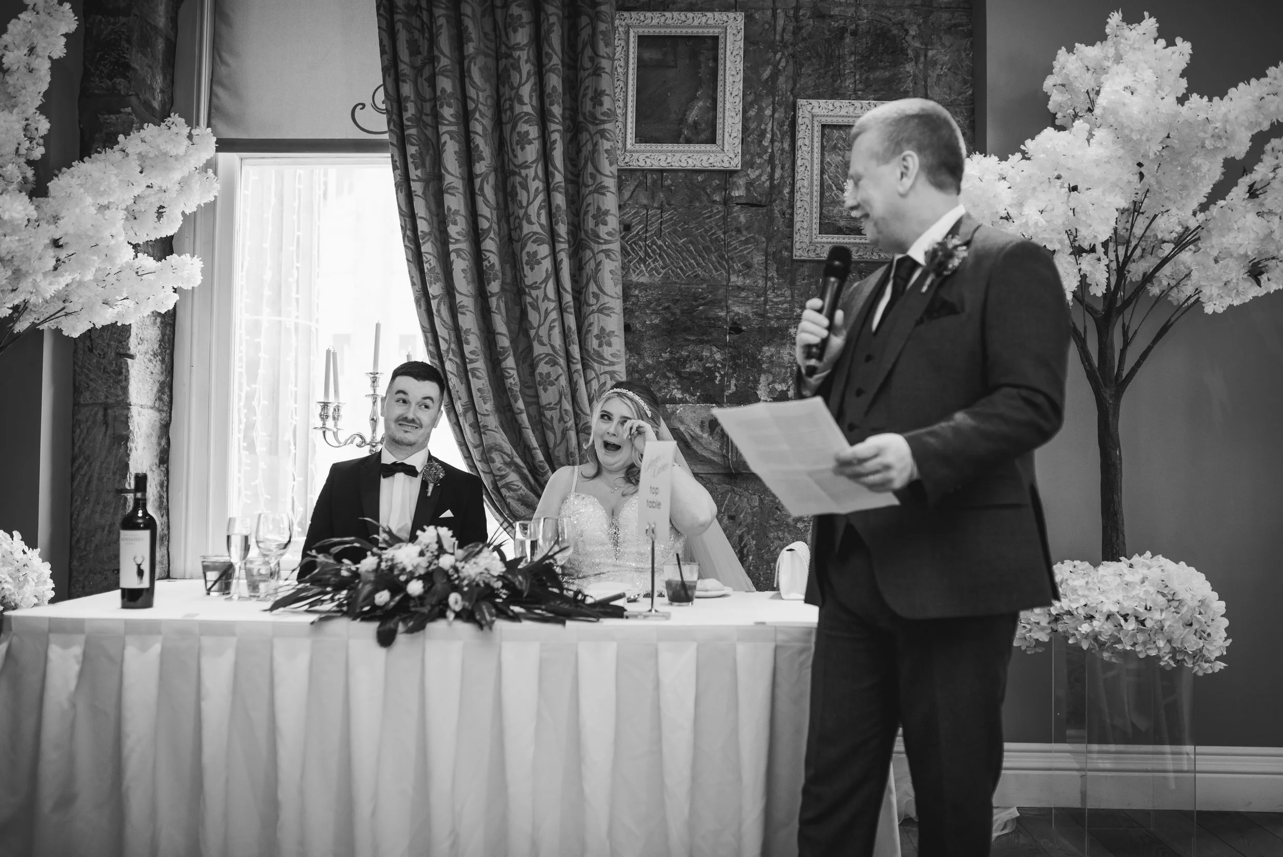 Groom giving a speech beside the newlyweds during their Glasgow wedding reception