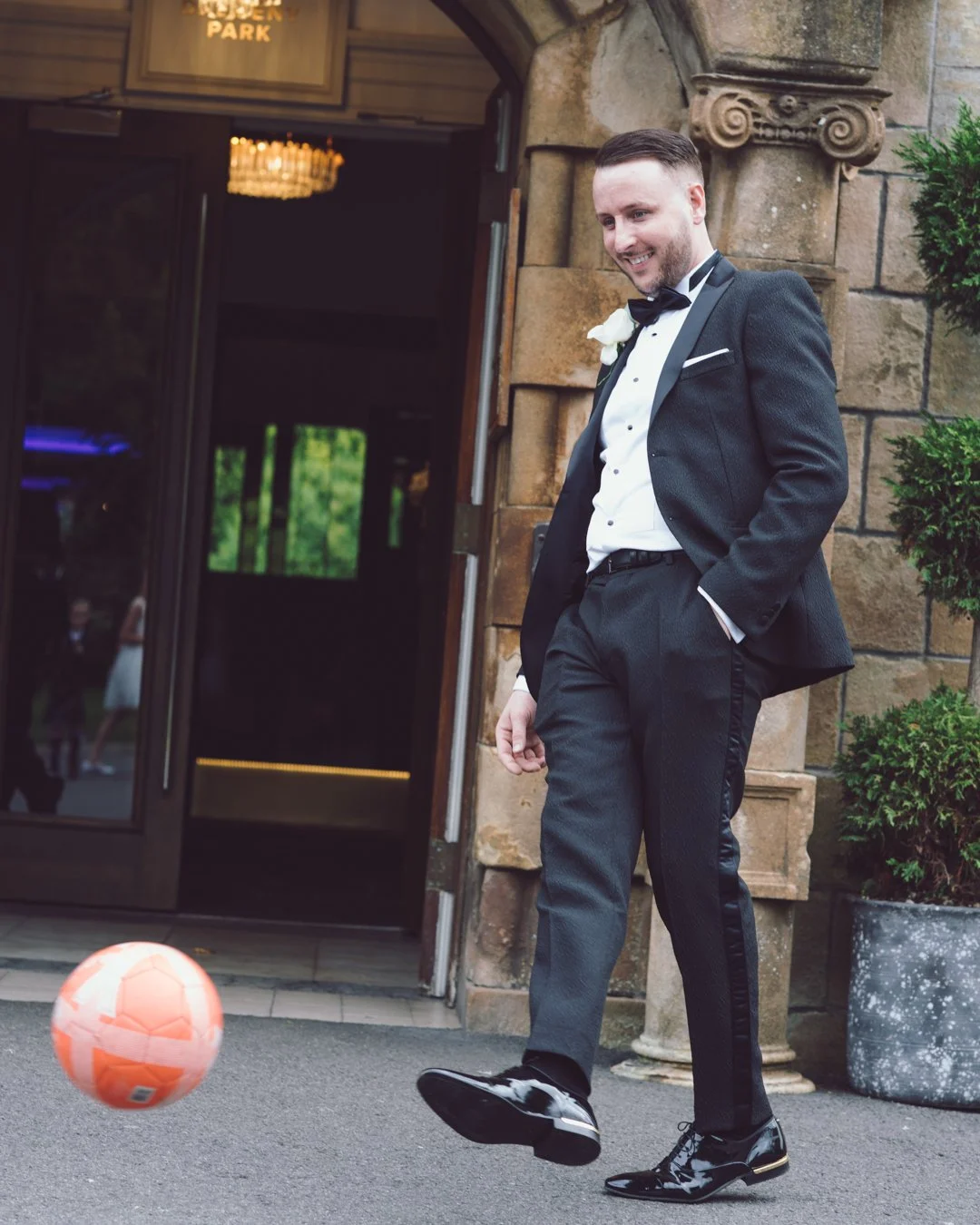 Groom enjoying a relaxed moment outside his wedding venue