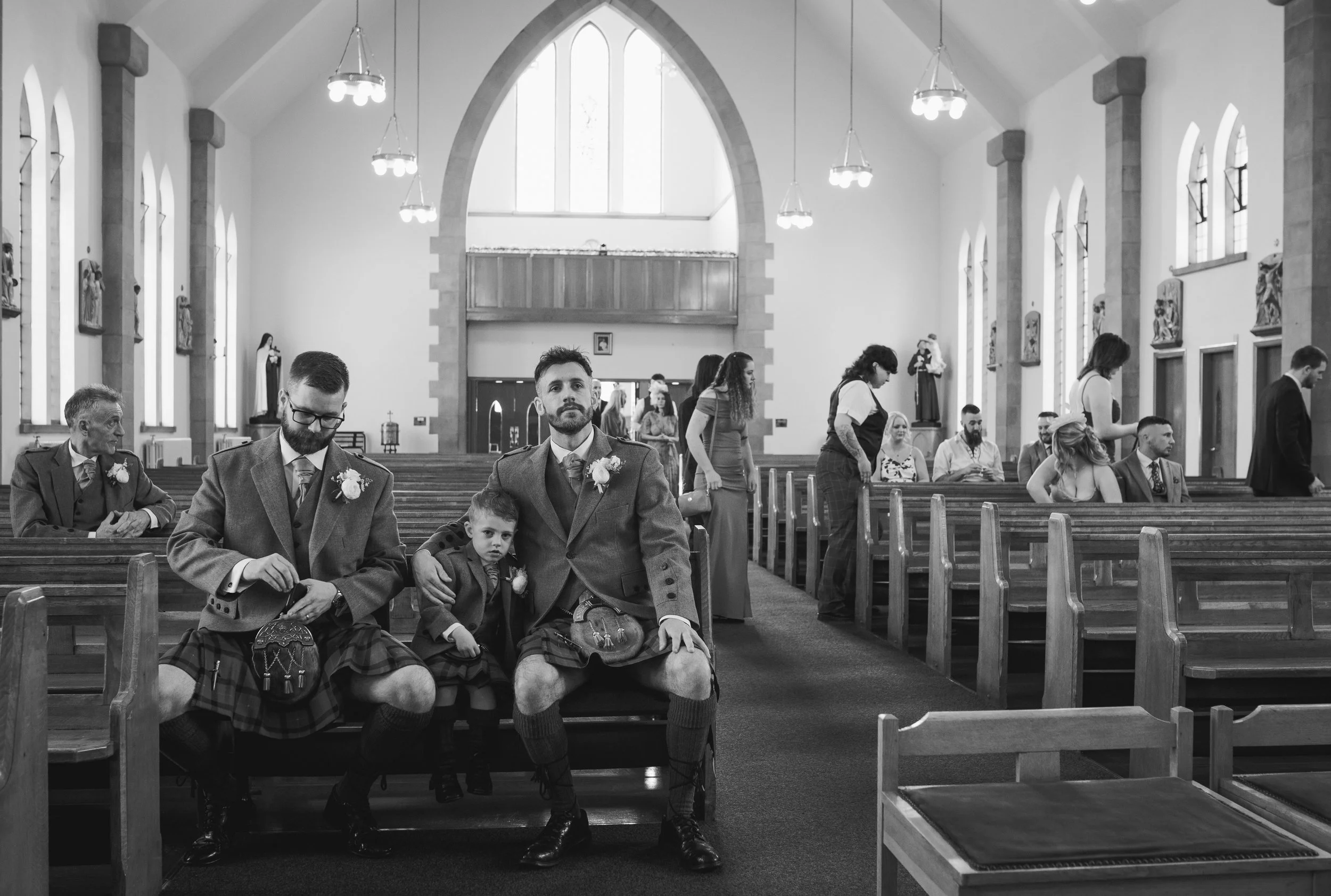 Groom and wedding party waiting inside the church before the wedding ceremony