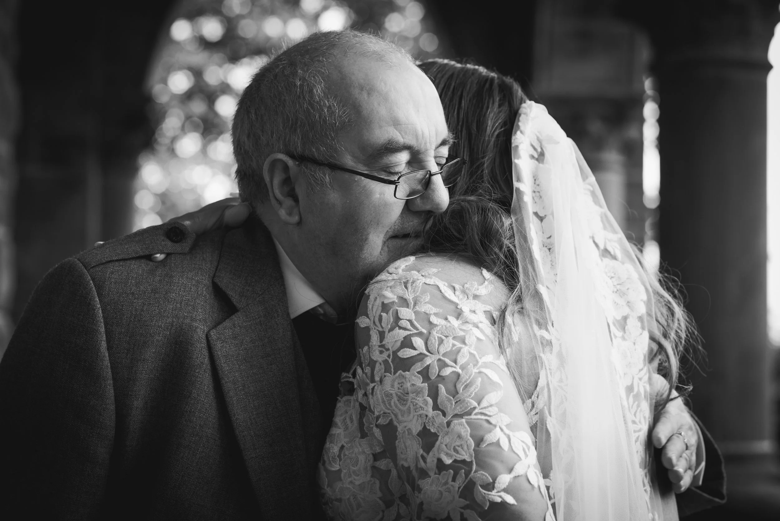 Emotional father embracing his daughter on her wedding day