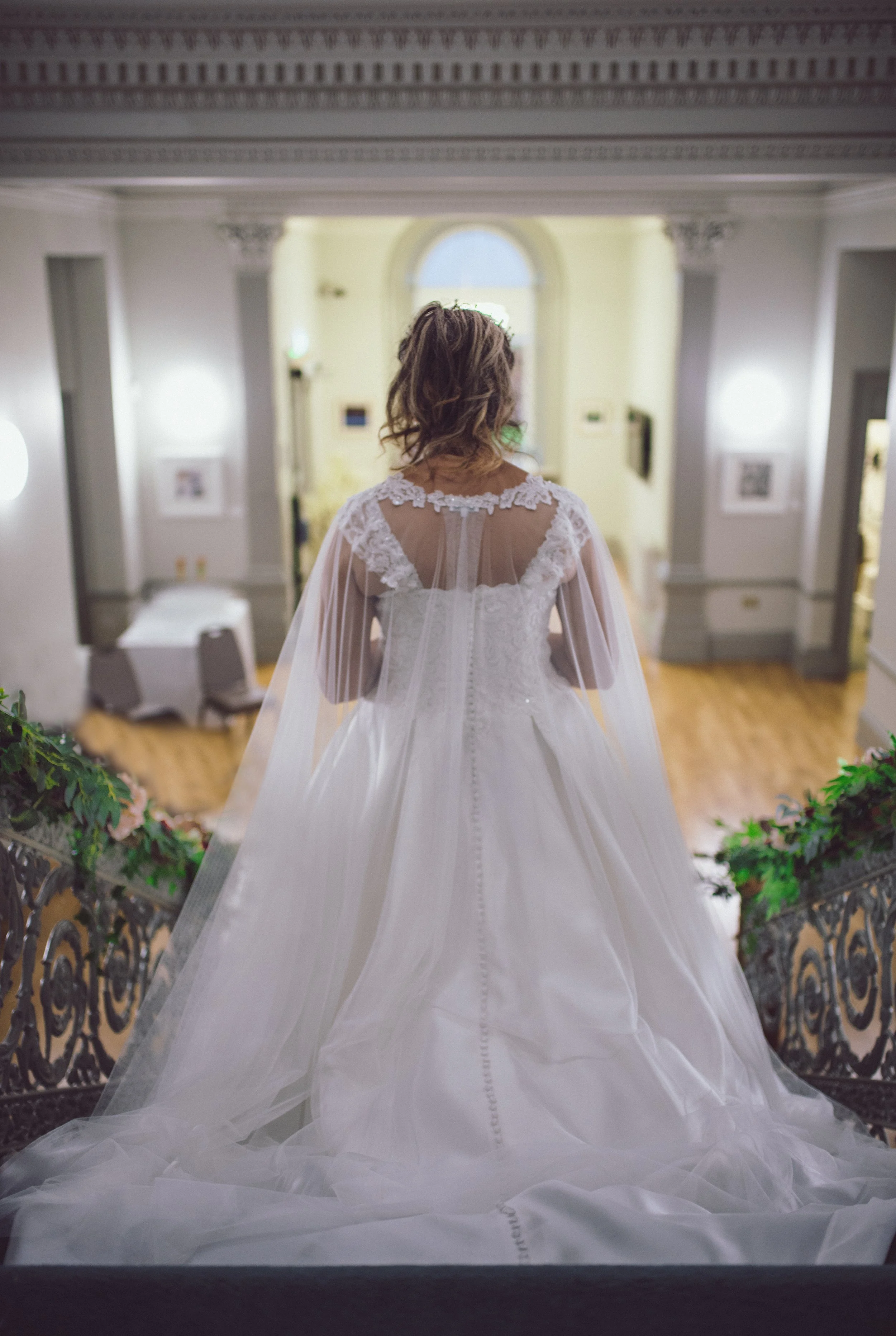 Bride walking through the wedding venue in her wedding dress
