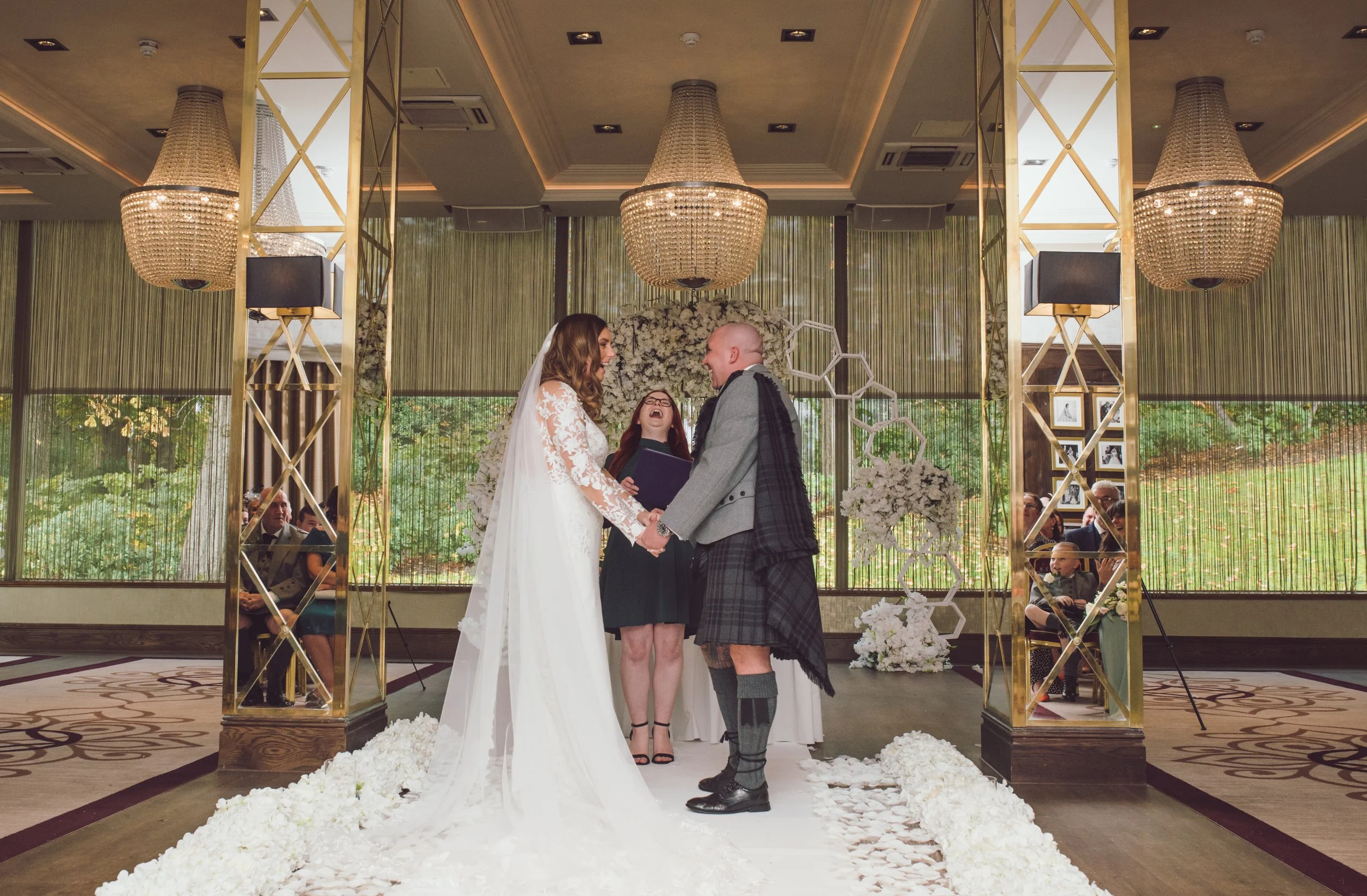 Bride and groom holding hands during their wedding ceremony