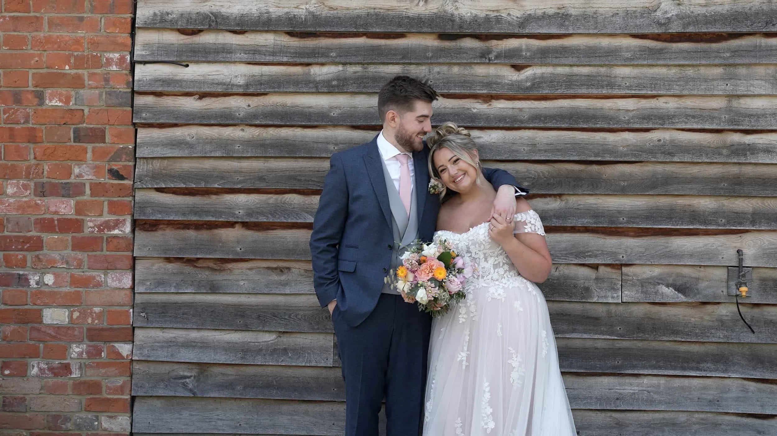 romantic couple lean Apton Hall. bride holding wedding bouquet cinematic videography