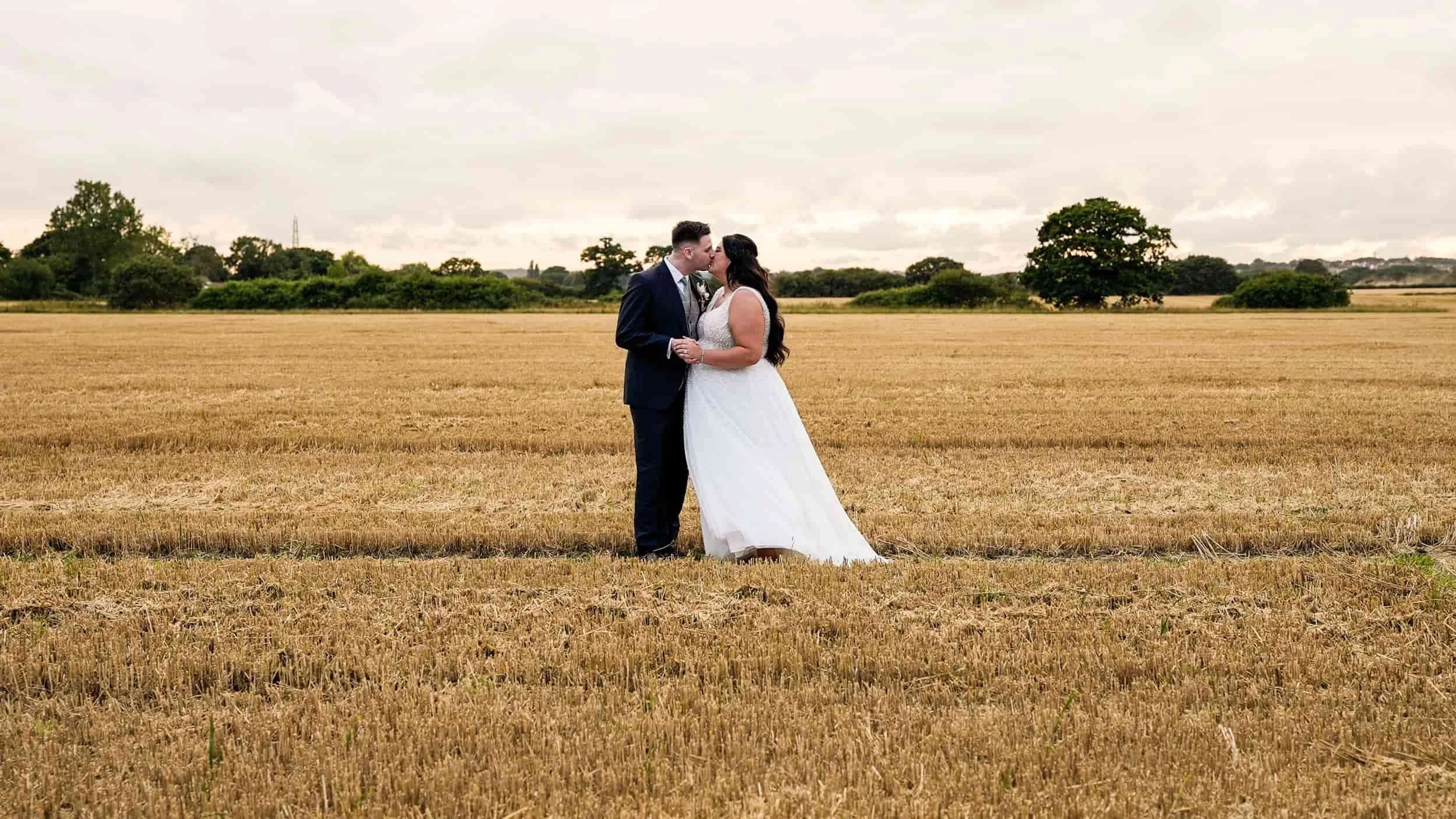 cinematic videography in fields Apton Hall. Couple kissing romantic unobtrusive natural
