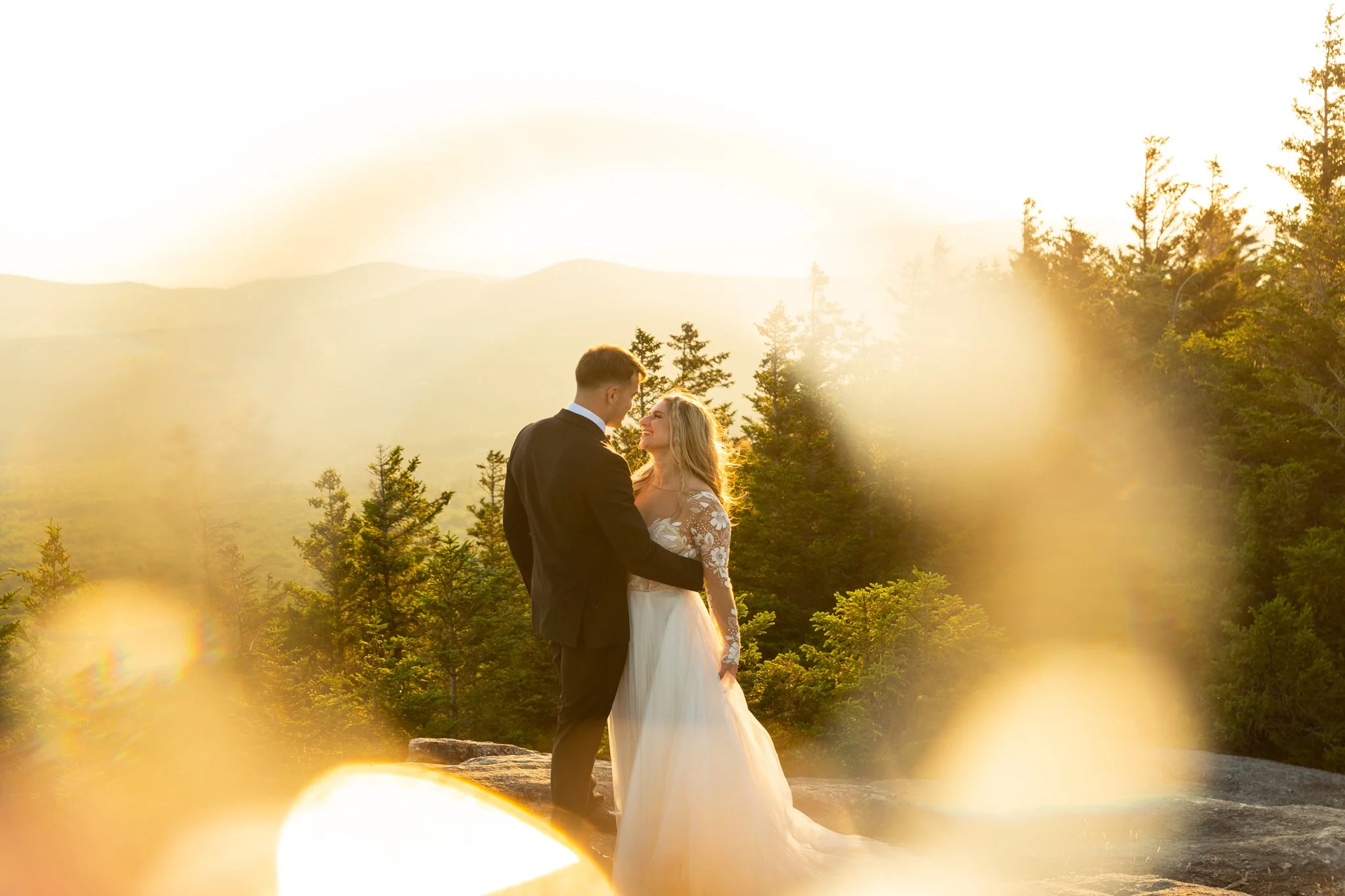 Couple celebrating their elopement in the White Mountains with sweeping New Hampshire mountain views at sunset