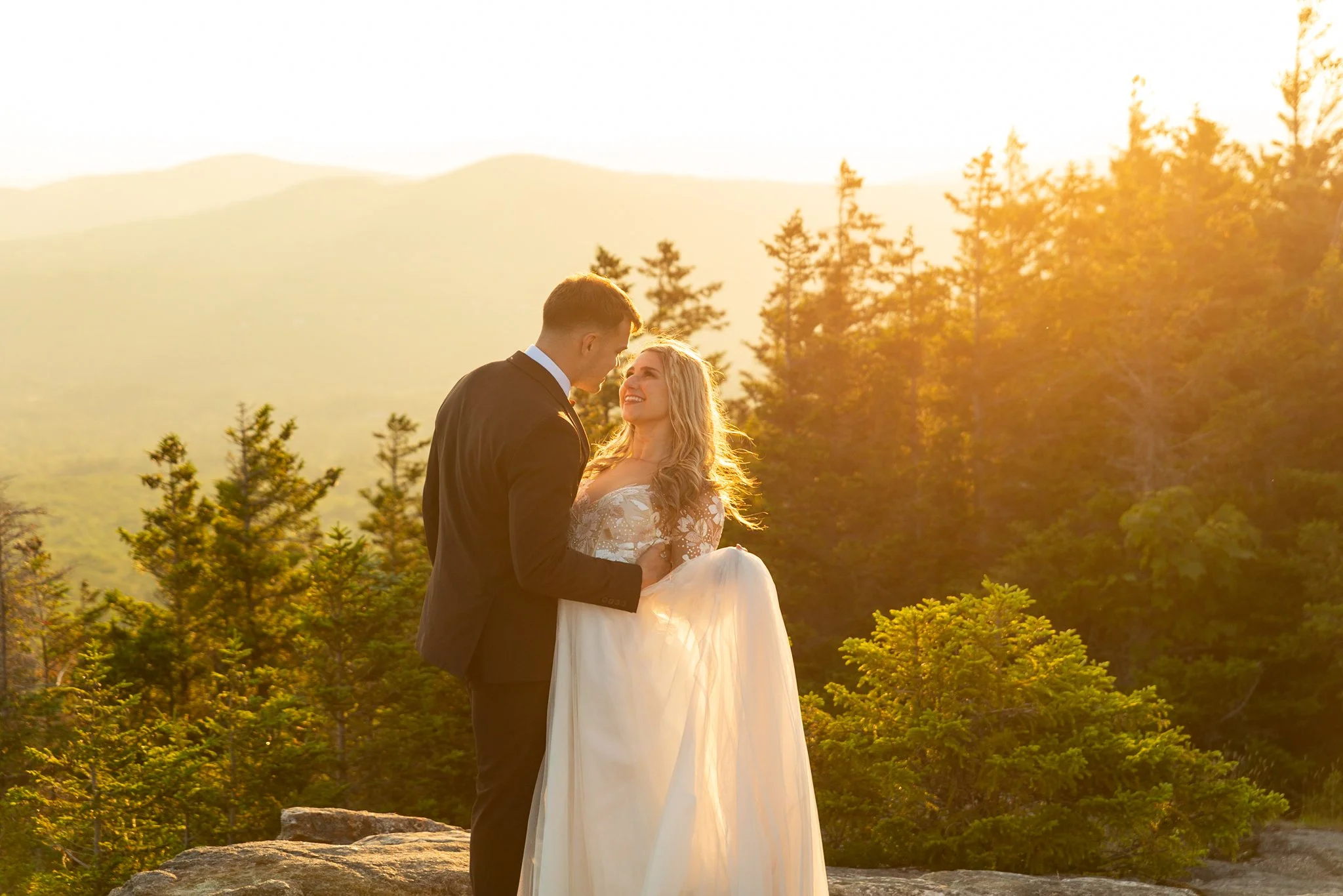 Adventurous couple sharing a quiet moment during their White Mountains elopement surrounded by alpine views at sunset
