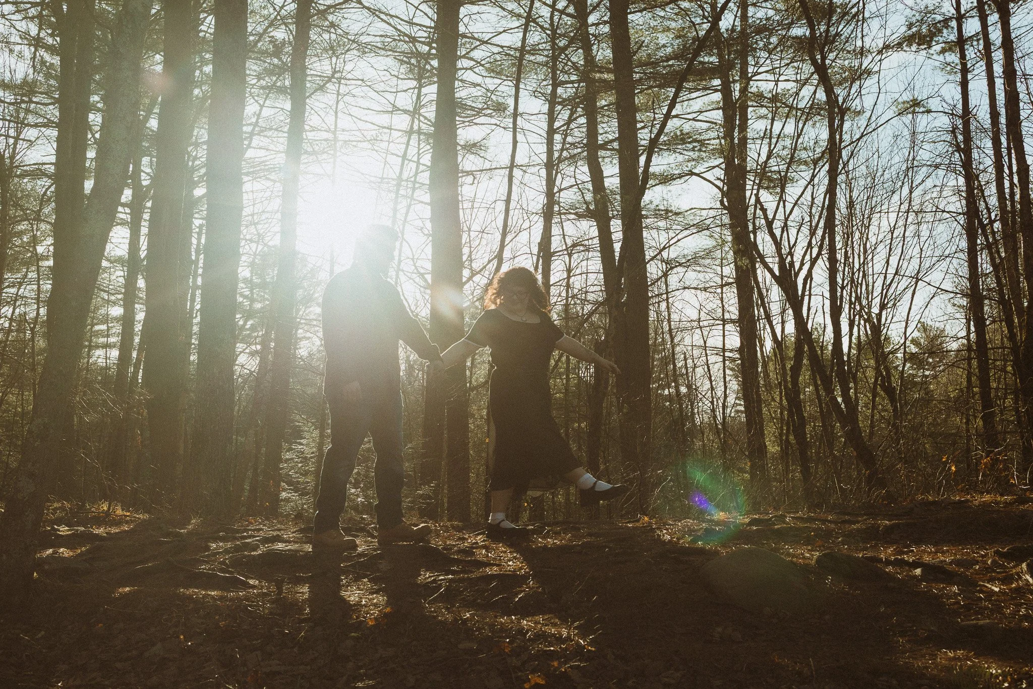 A young couple walking along a ridge on Foster Pond Trail in Windham, NH