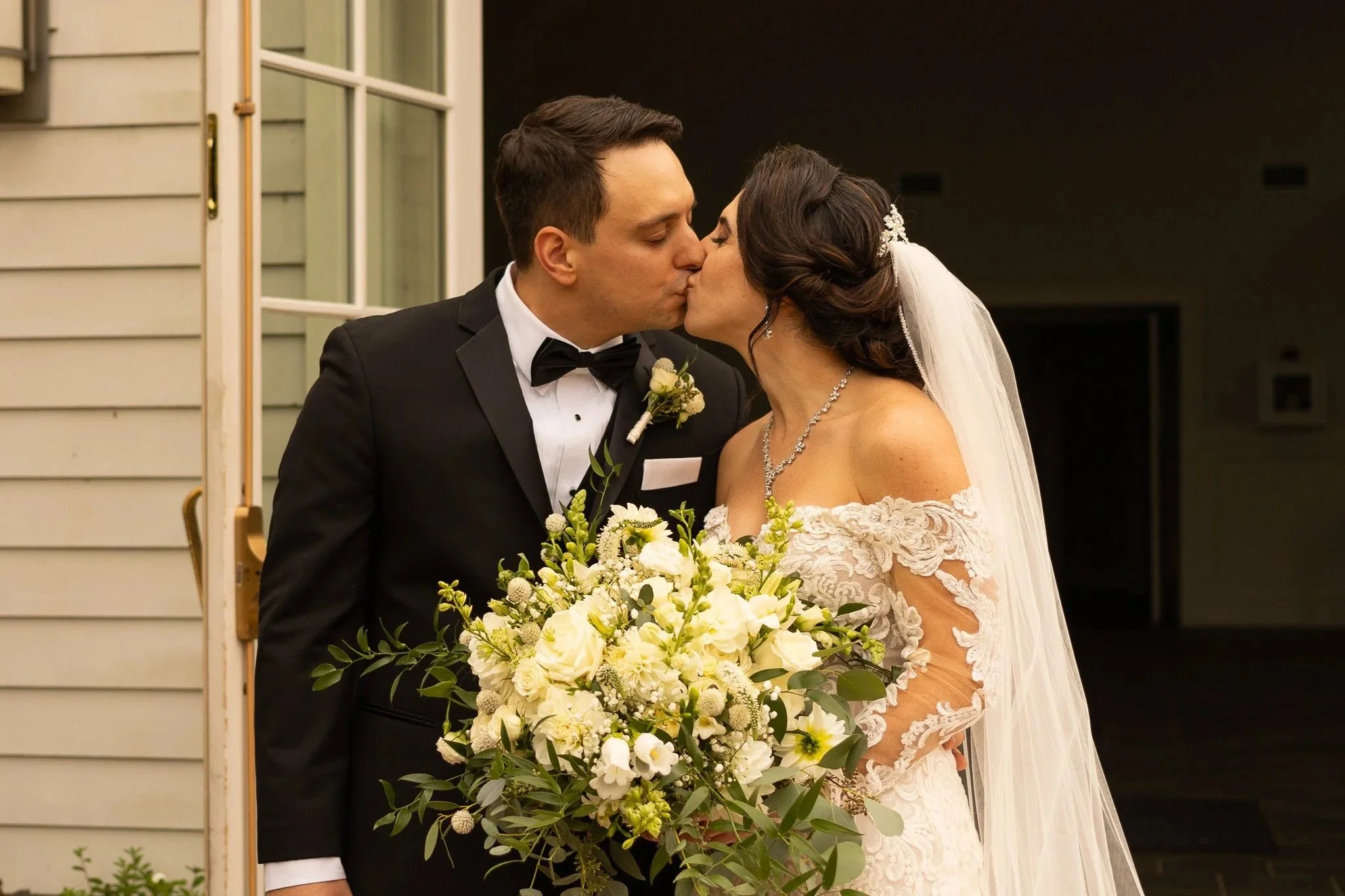 Couple exiting a church and kissing after their ceremony