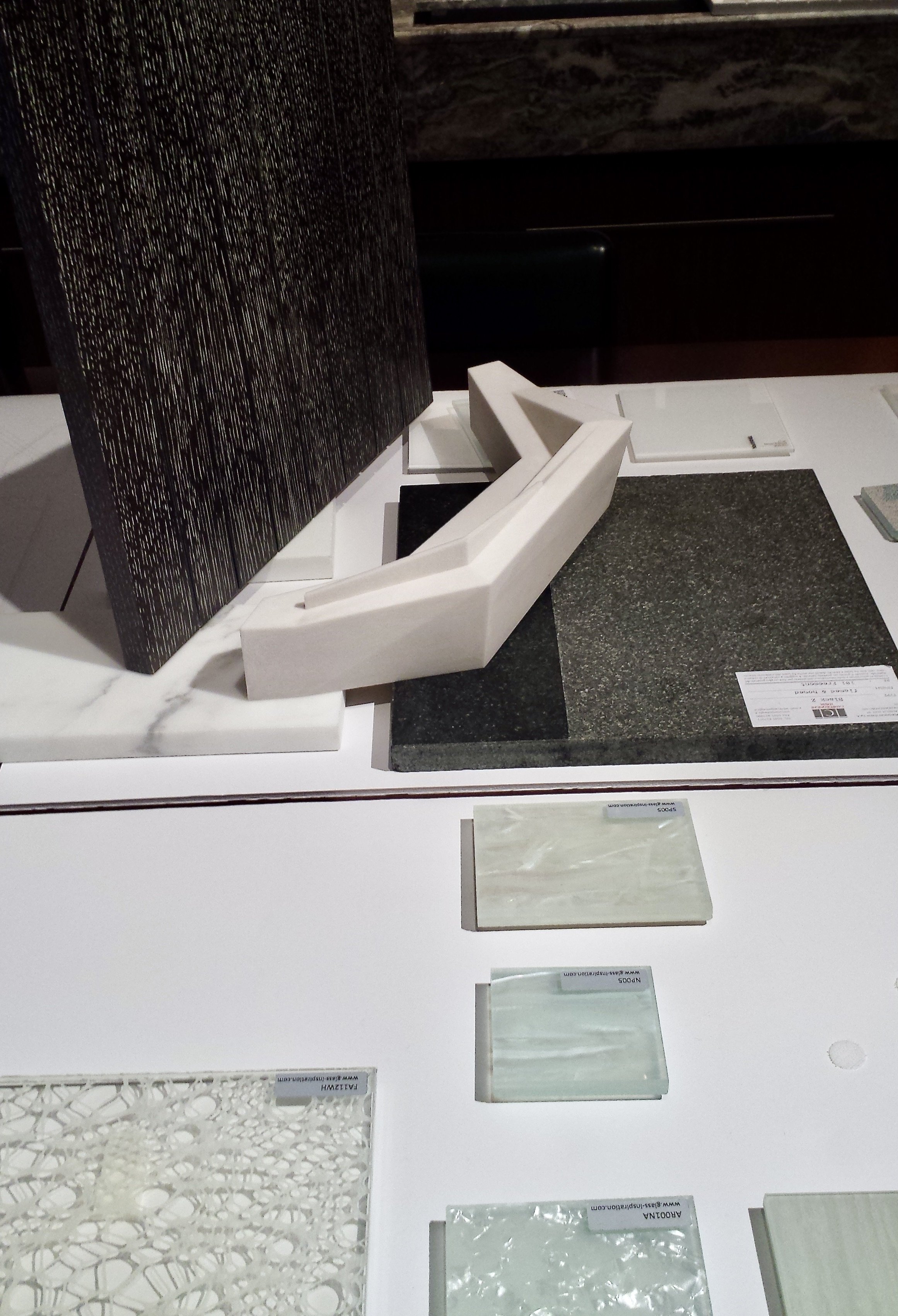 Ground floor commercial lobby design meeting, showing 3D print of security desk, floor, and wall materials