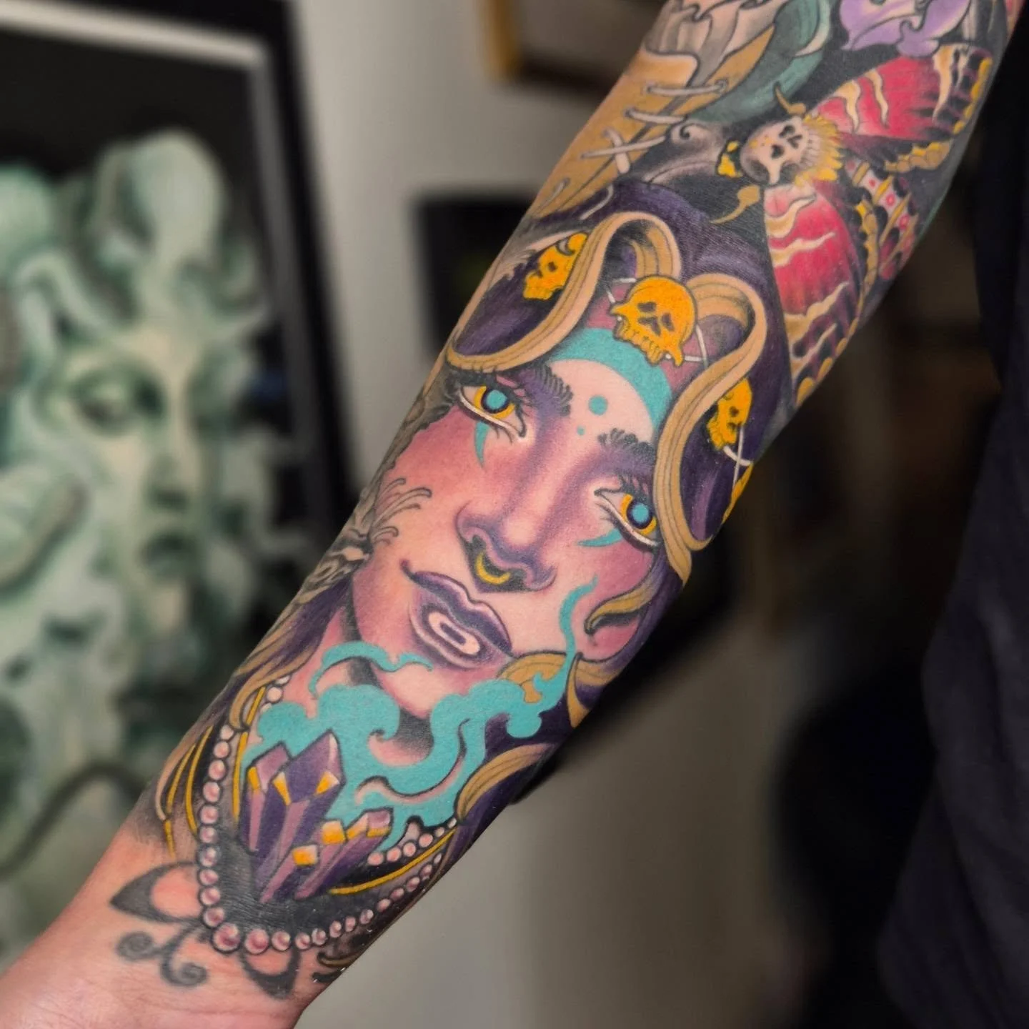 Tattoo of a woman's face with long hair and roses on her head, featuring vibrant colors and detailed shading.