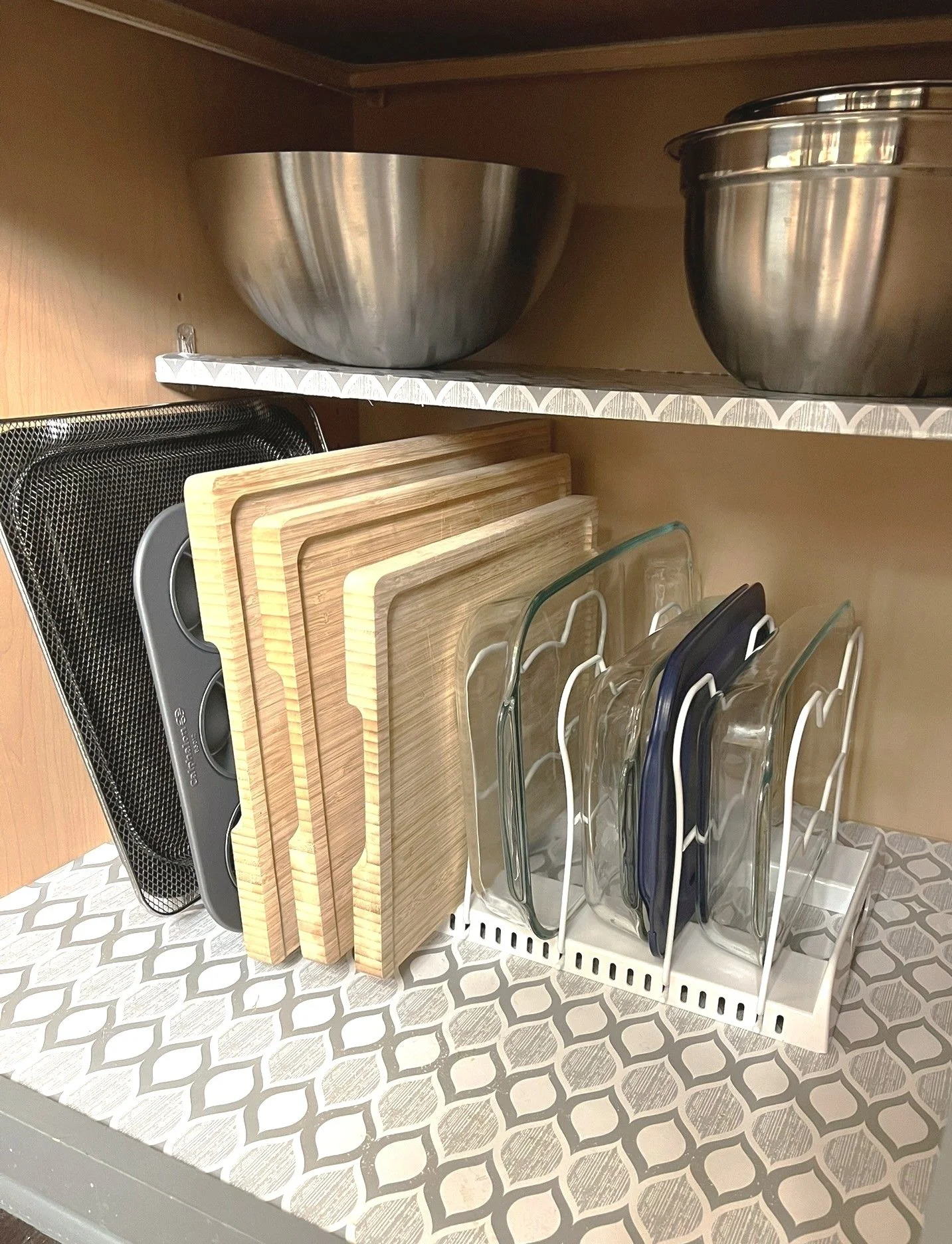 Kitchen tip:

Try using a vertical organizer for things like your baking sheets, 9 x 13 pans, cutting boards etc. Eliminating stacking is one way to help keep your messy cabinets just a little tidier!