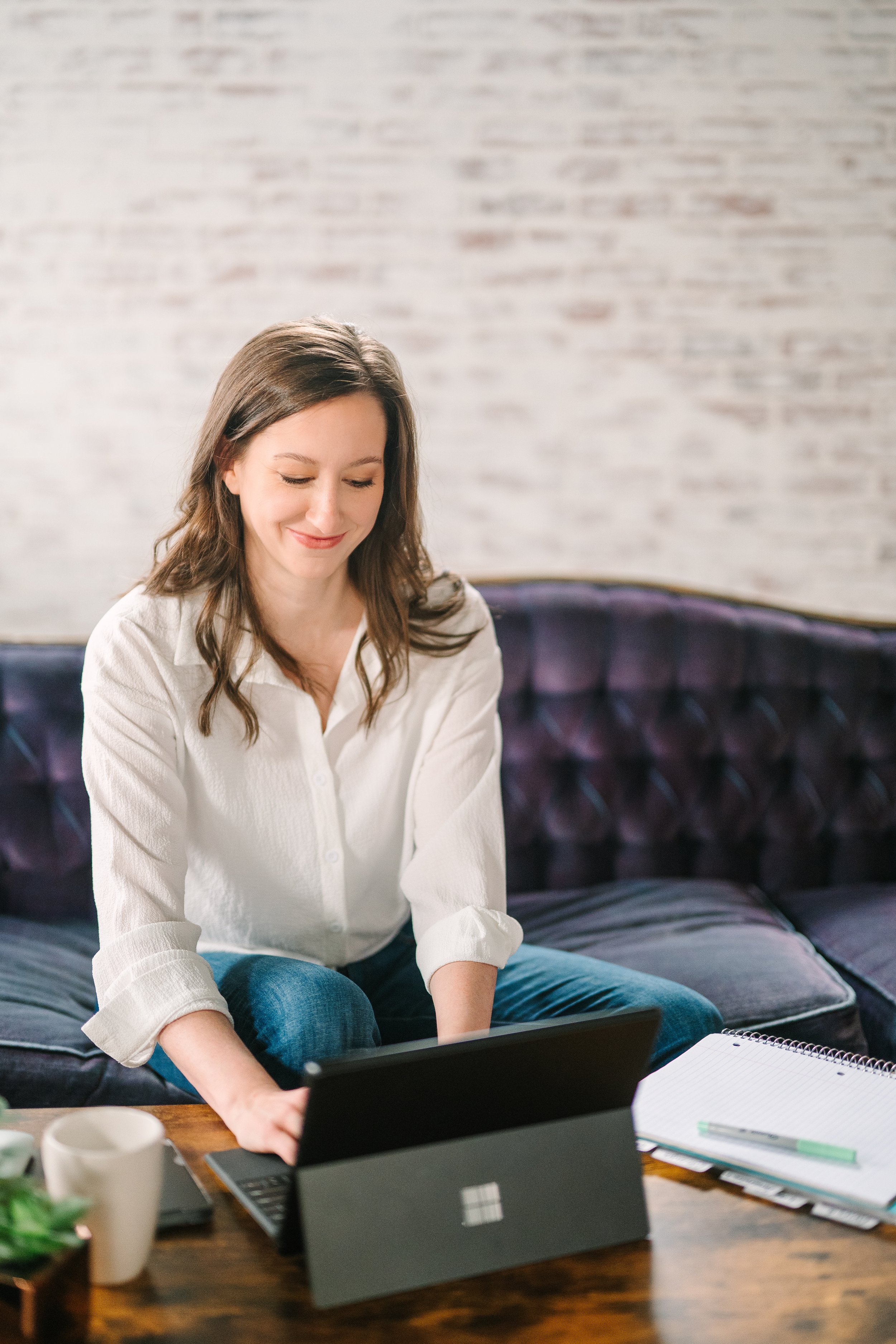 Alli B Typing on a computer to connect with clients for decluttering accountability