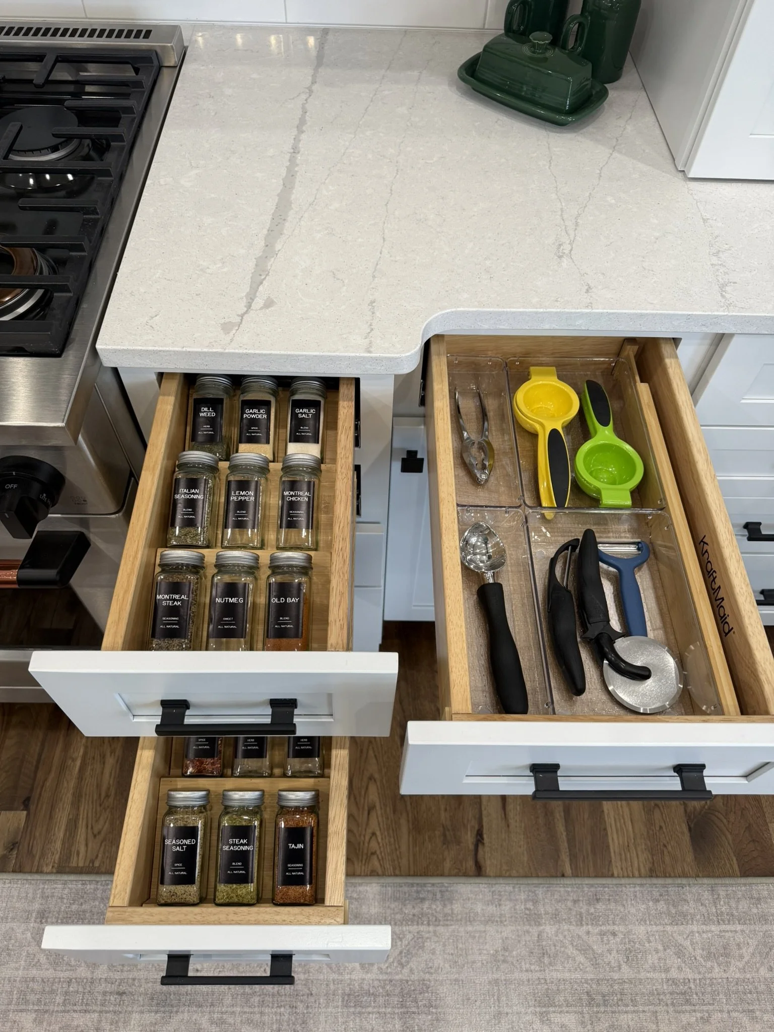 Drawers filled with labeled spice jars and drawer organizers with gadgets