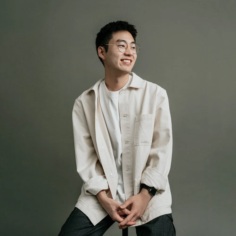 Justin Joo smiling in a light shirt