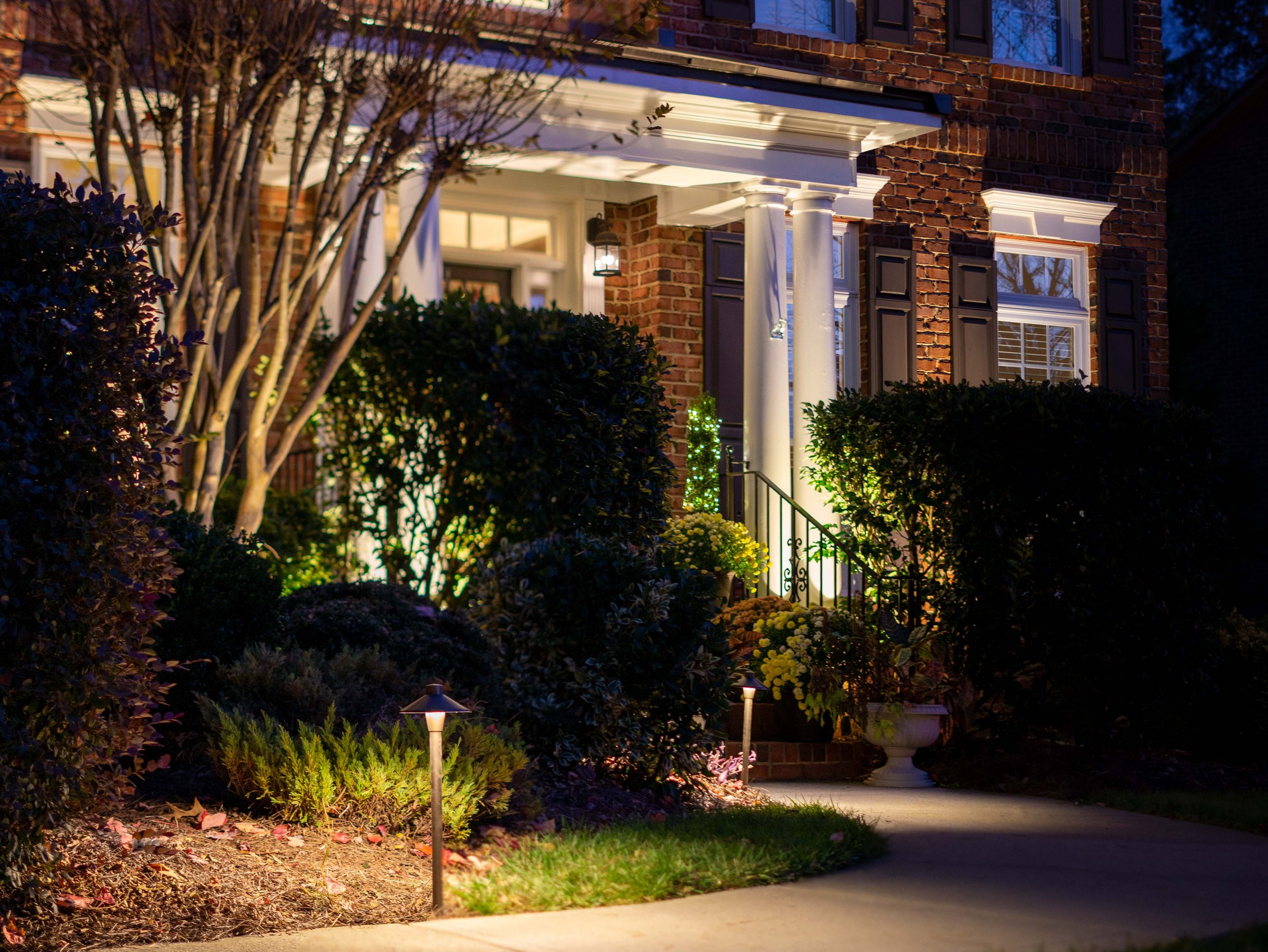 Inviting front of home illuminated with professionally designed and installed landscape lighting.  