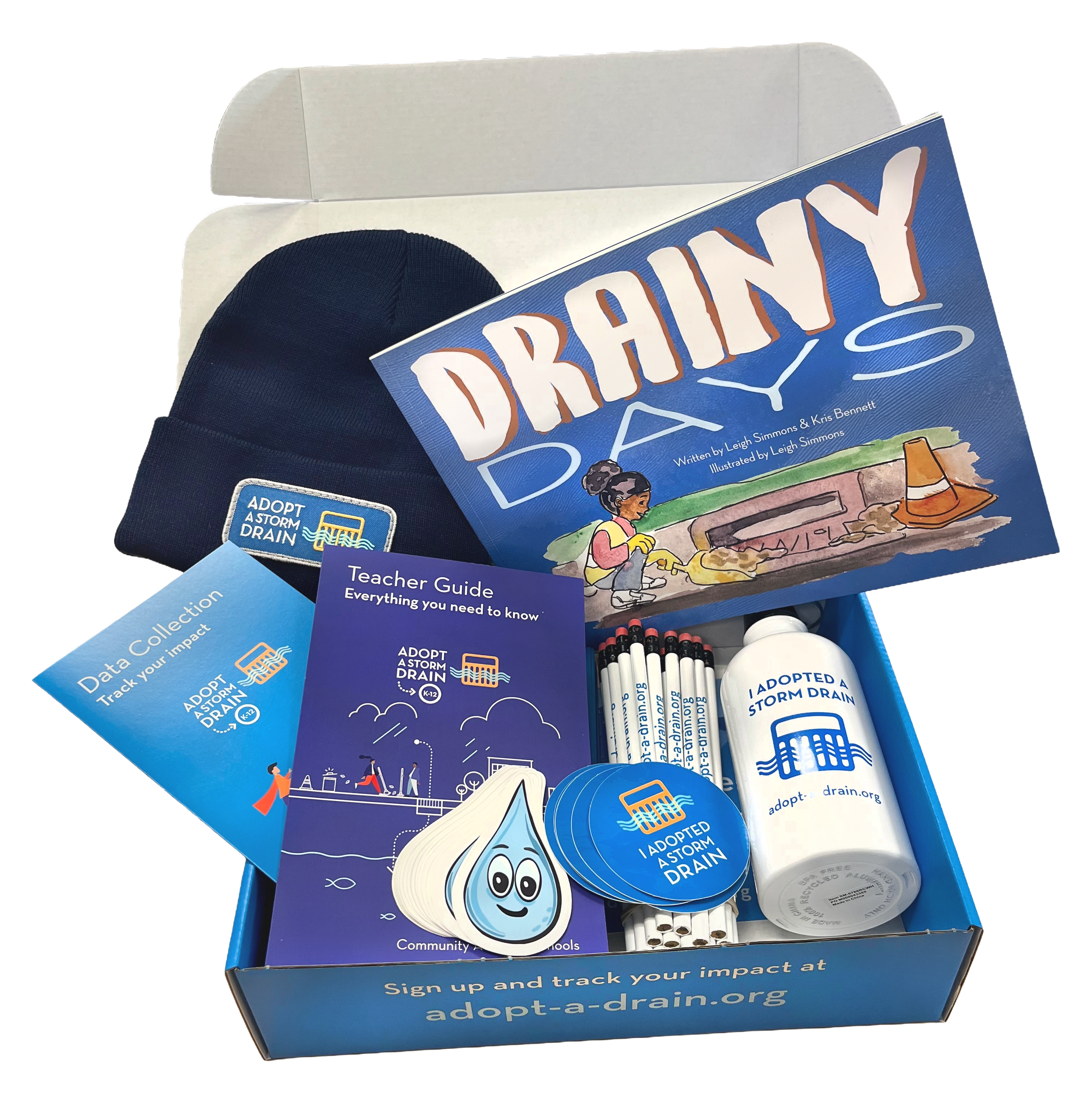 An open classroom kit box containing teacher materials, stickers, pencils, a water bottle, and a baseball cap.