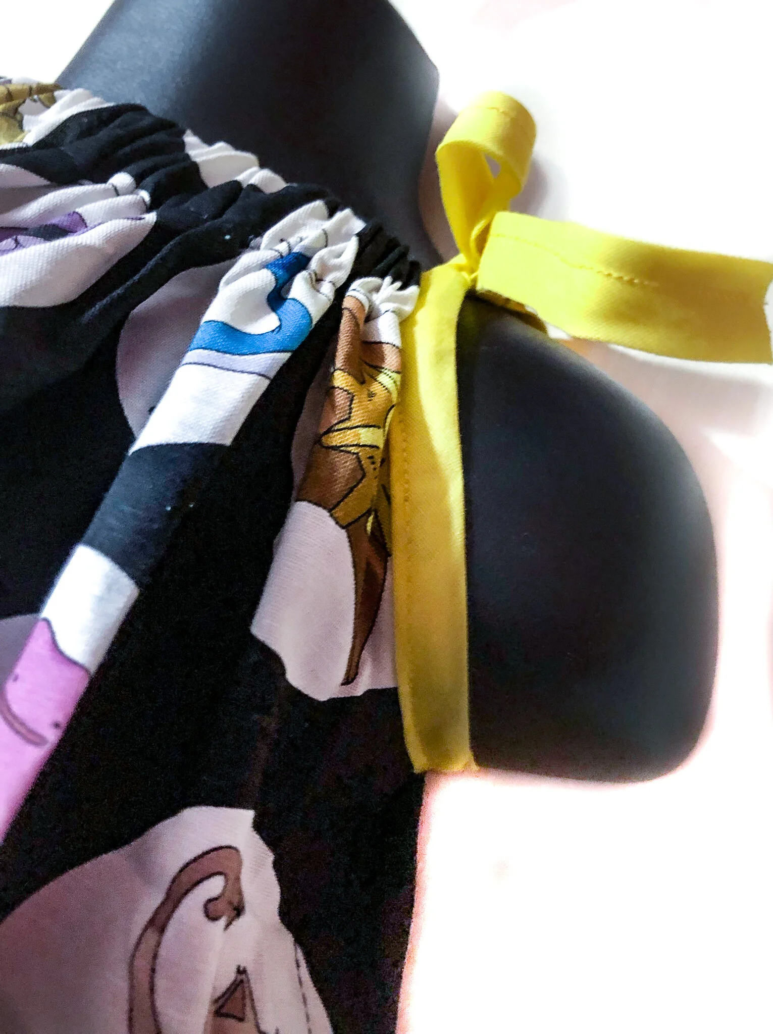 Kid's Pokemon Dress Featuring Different Pokemon on a black background Close Up on Yellow Tie Straps