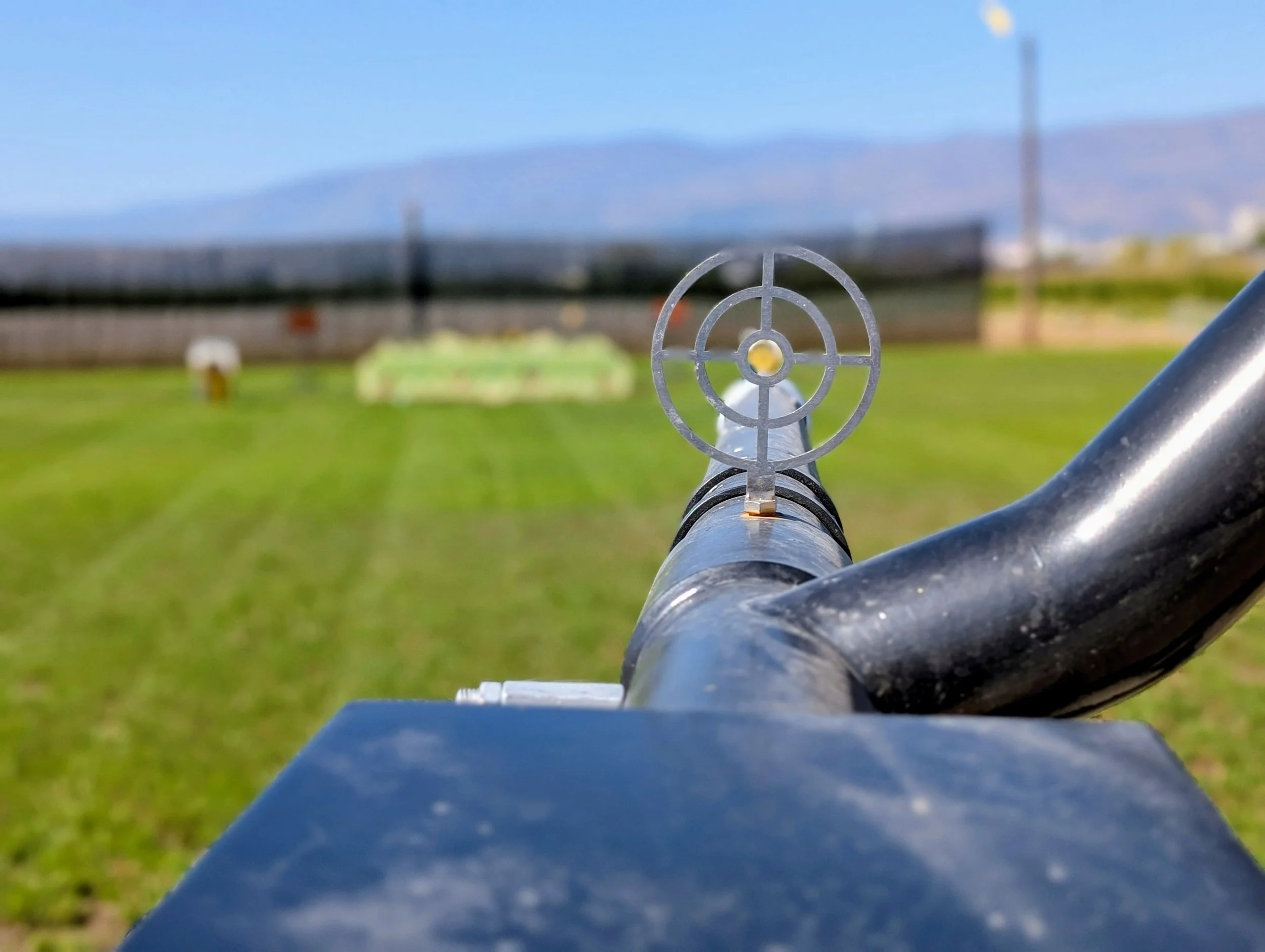 Looking down the barrel of an air cannon through the sight at the target range 